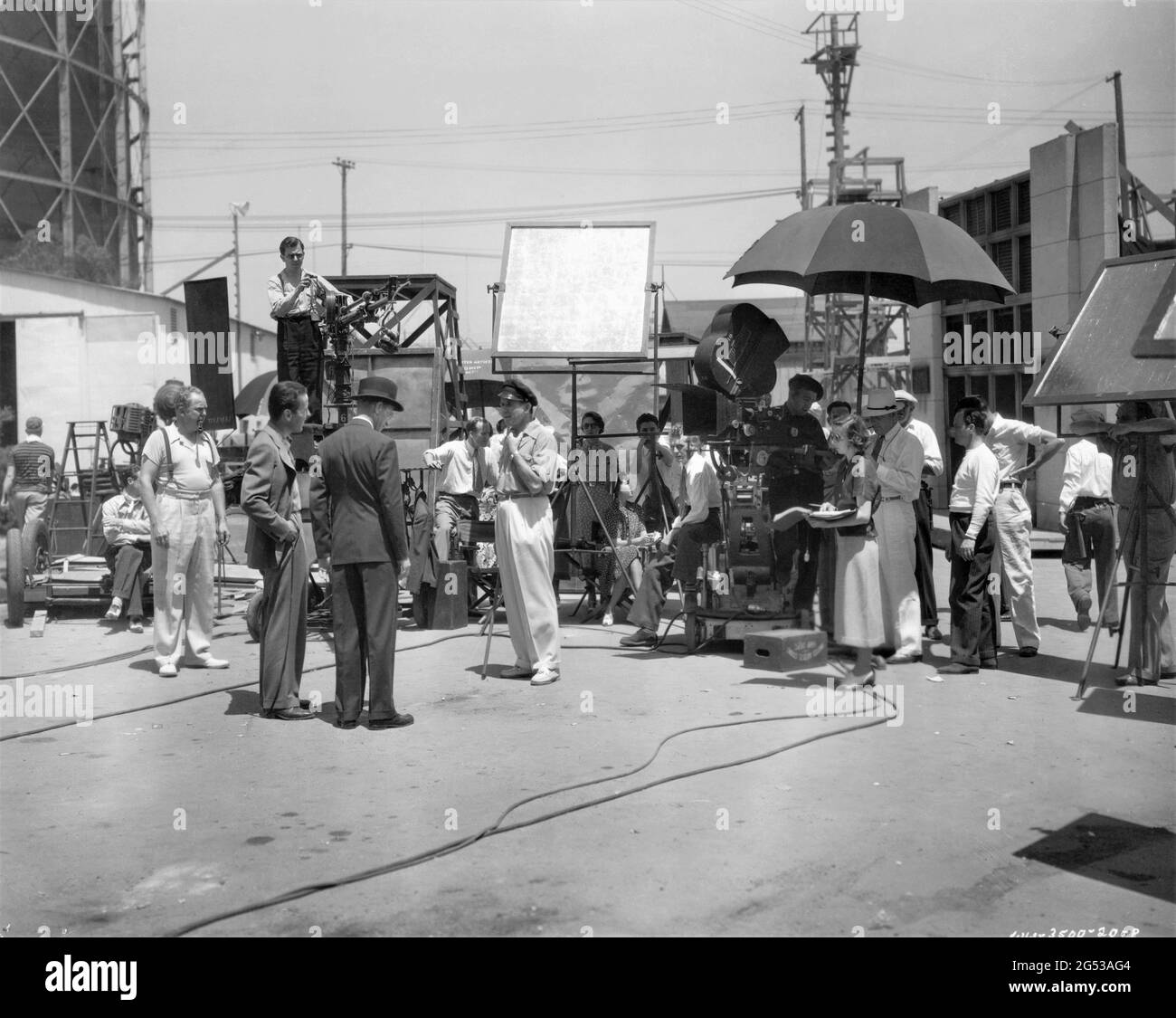 HUMPHREY BOGART and LESLIE HOWARD being directed by TAY GARNETT on set candid with Movie Crew during filming of STAND-IN 1937 director TAY GARNETT based on the novel by Clarence Budington Kelland Walter Wanger Productions / United Artists Stock Photo