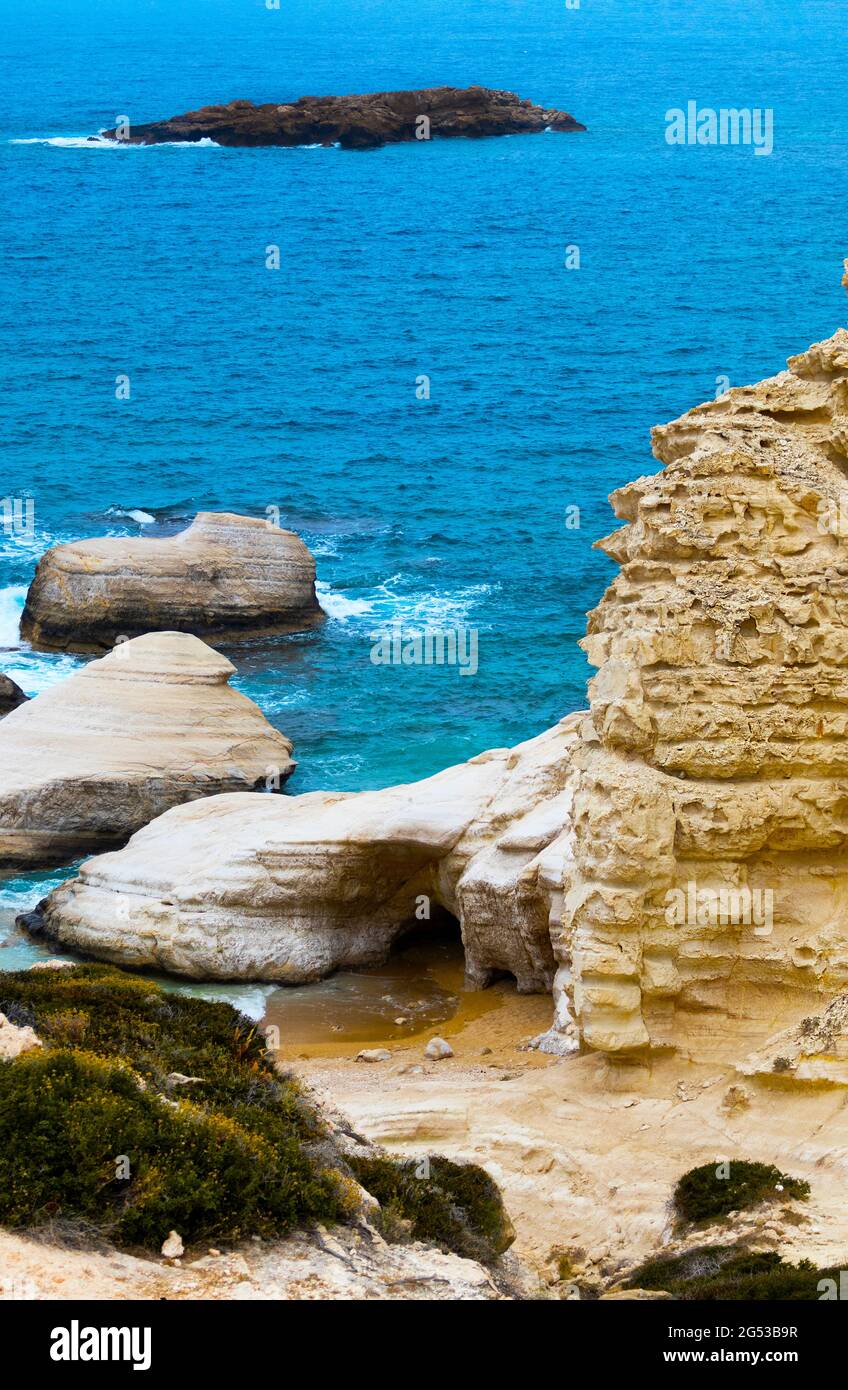 Ocean waves splash against beach with rocks background, Cliffs in the sea, Top aerial view of