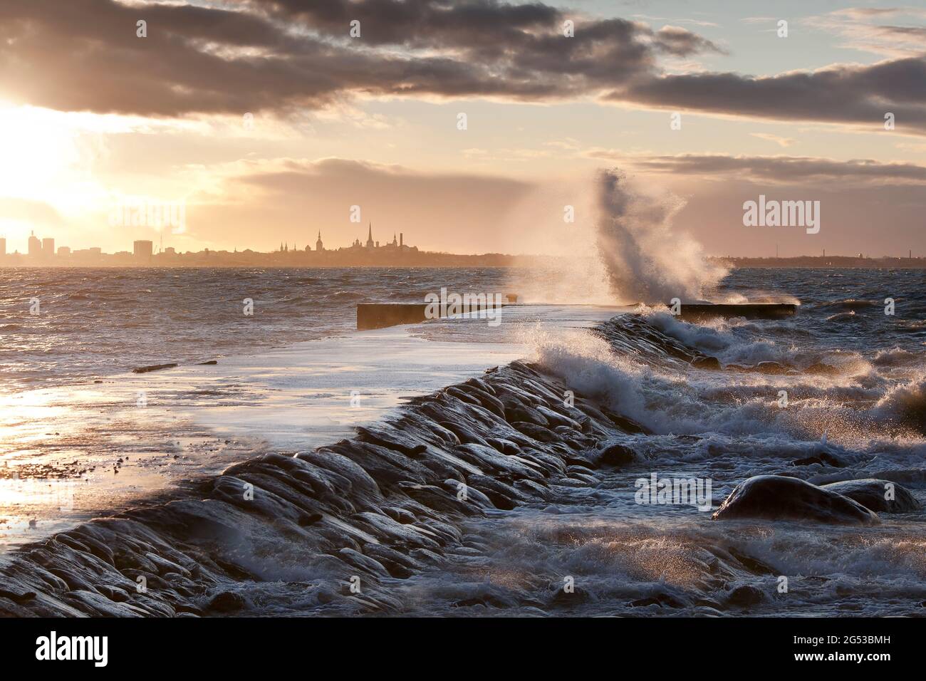 A weather storm in the Baltic Sea, waves crashing over a pier Stock Photo