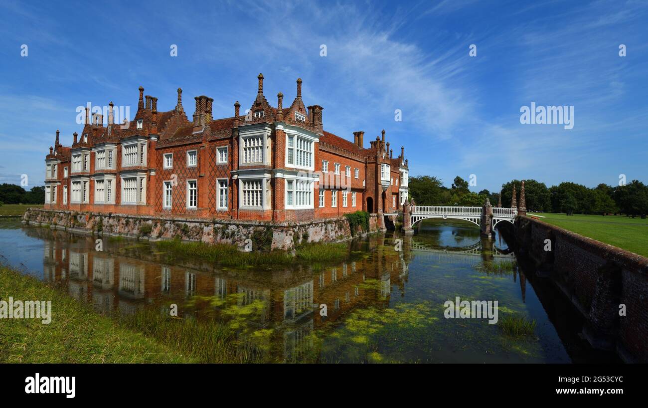 Helmingham Hall with moat bridges and reflections. Stock Photo