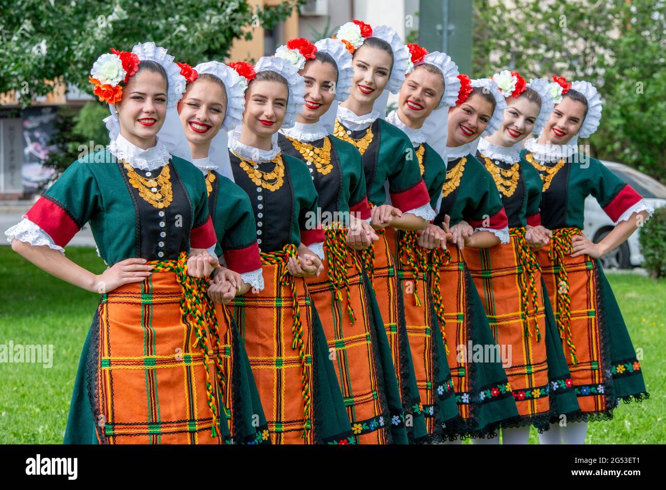 Sliven, Bulgaria - June 20th 2021: Young women wearing traditional Bulgarian folklore dresses Stock Photo