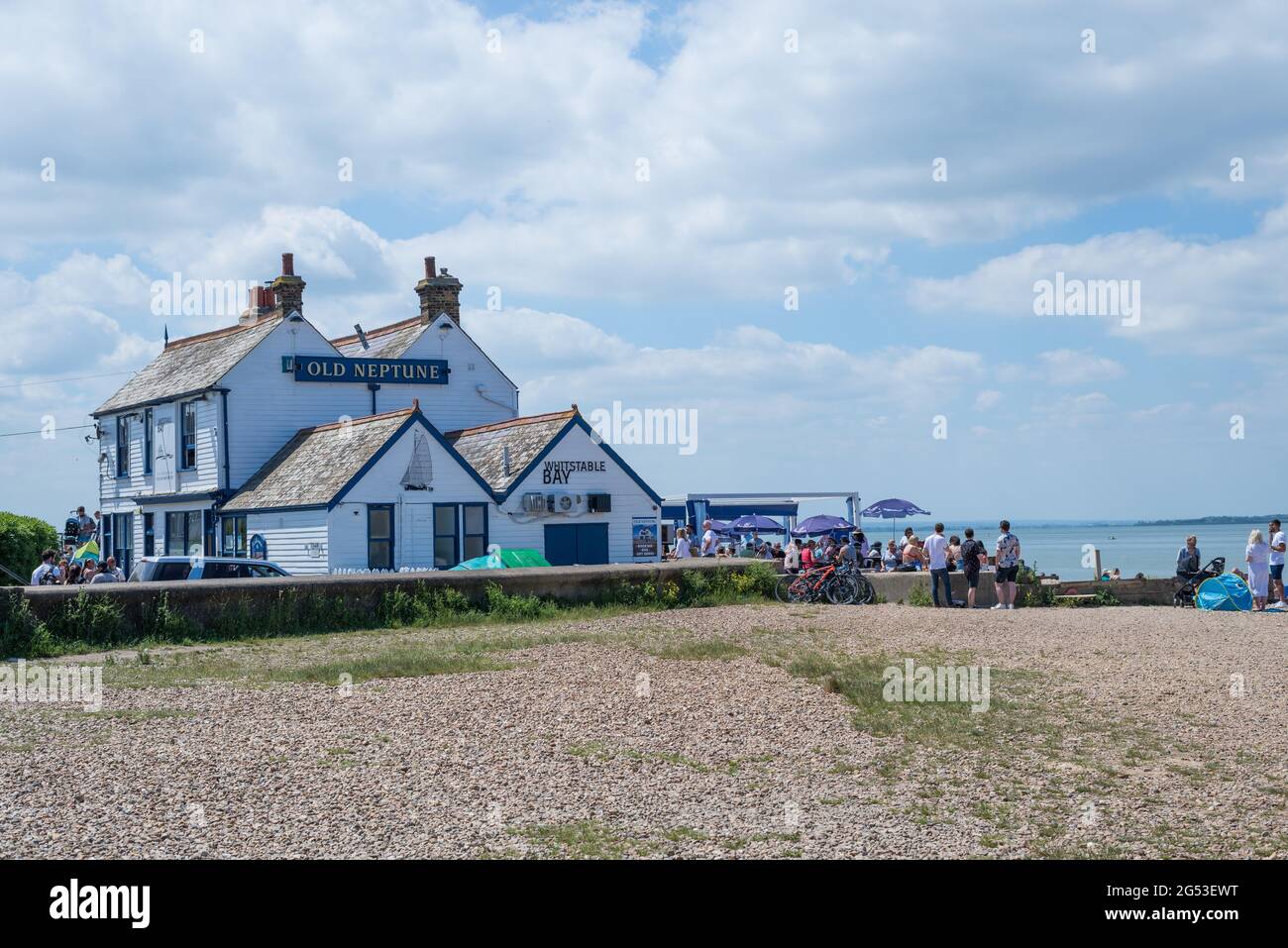 The Old Neptune, a beachside pub and restaurant in the seaside town of Whitstable. People outside enjoying food and drink. Kent, England, UK. Stock Photo