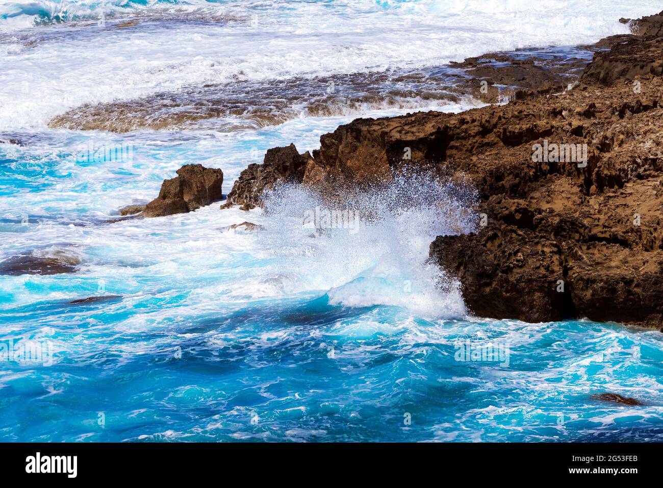 Ocean waves splash against beach with rocks background, Cliffs in the sea, Top aerial view of
