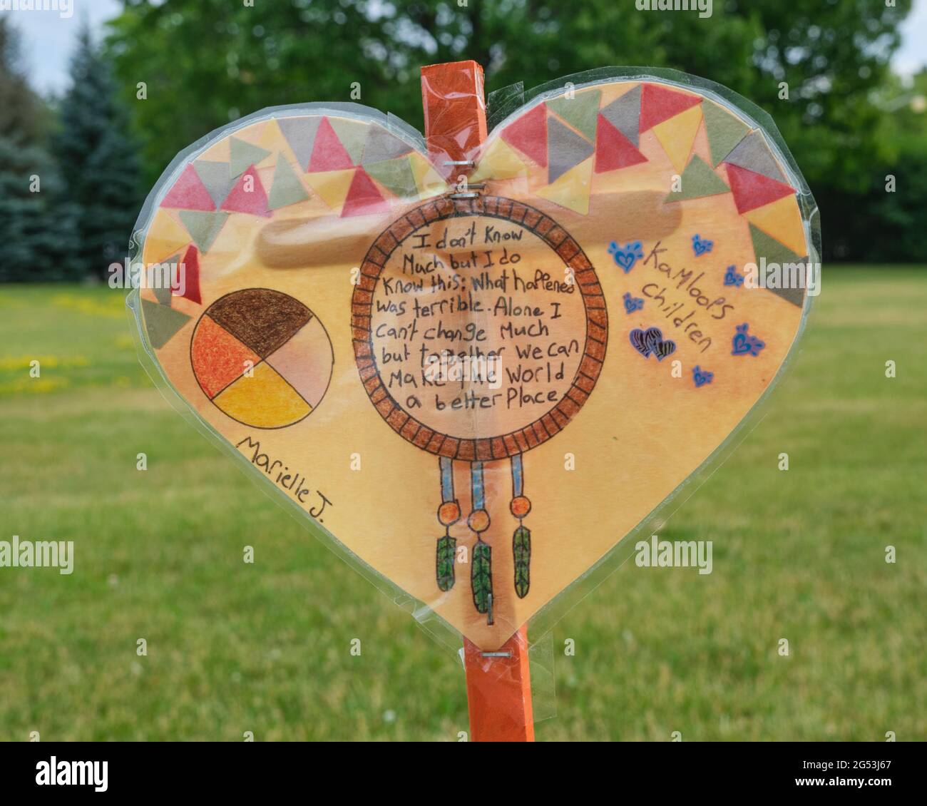 Ottawa, Canada. June 25th, 2021. Hearts drawn by member of the community in memory of the lost children of Canadian Indian Residential Schools and planted in the Heart Garden at 50 Sussex Drive in the nation's Capital. The Heart Garden was created by advocates of Indigenous social justice to first memorialize the children who died in the Indian Residential School in Kamloops, but now growing as Canada continue to grapple with the legacy of the Residential School System which remained in place until 1996. Credit: meanderingemu/Alamy Live News Stock Photo