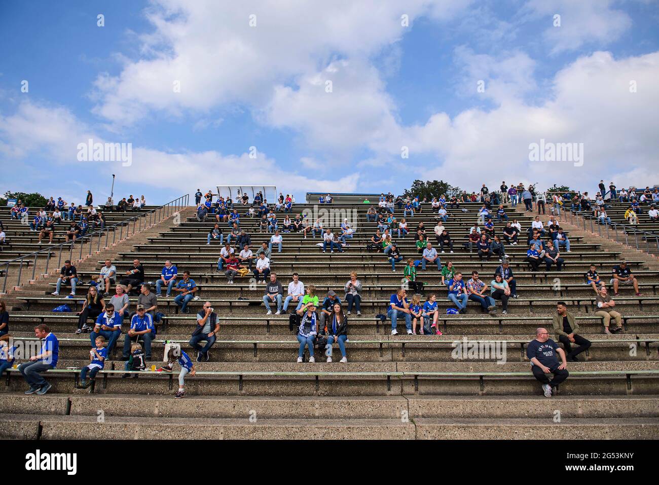 Feature, fans sit at a distance on the tribune in the new Parkstadion soccer test match, FC Schalke 04 (GE) - PSV Wesel-Lackhausen, 8: 0 on June 23, 2021 in Gelsenkirchen / Germany. Â Stock Photo