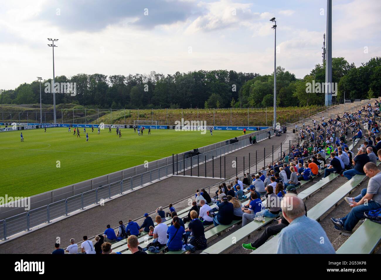 Feature, fans sit at a distance on the stands in the Parkstadion and watch the game, soccer test match, FC Schalke 04 (GE) - PSV Wesel-Lackhausen, 8: 0 on June 23rd, 2021 in Gelsenkirchen / Germany. Â Stock Photo
