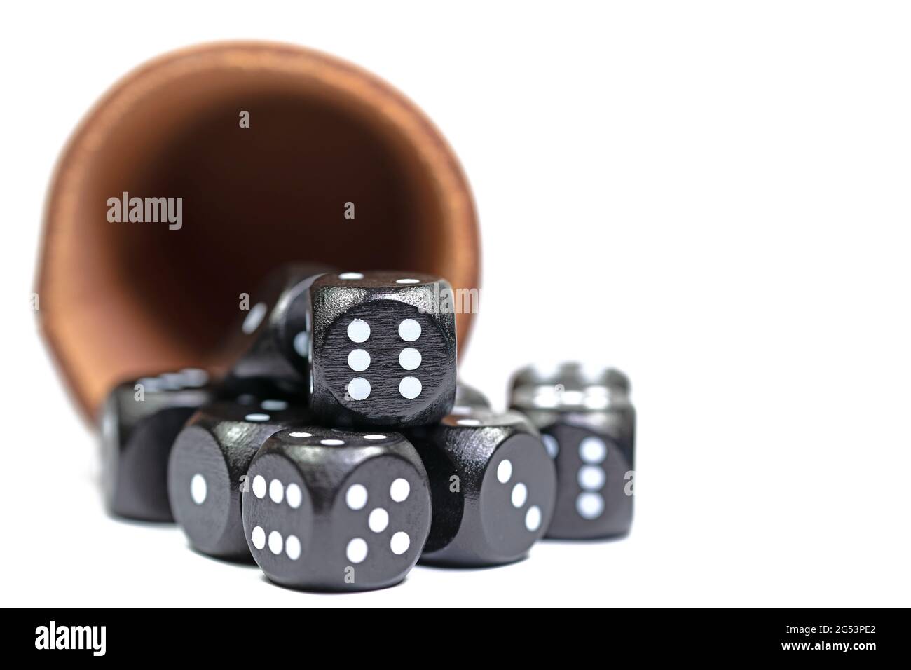 Black dice and dice cups against a white background Stock Photo