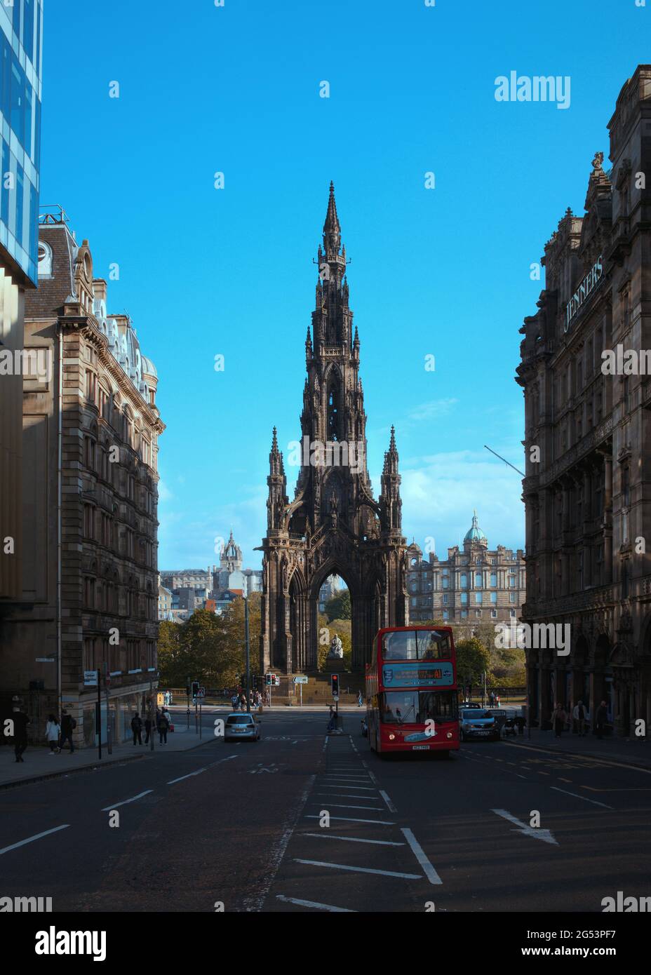 View of the Scott Monument from S St David Street and red bus, Edinburgh, Scotland Stock Photo