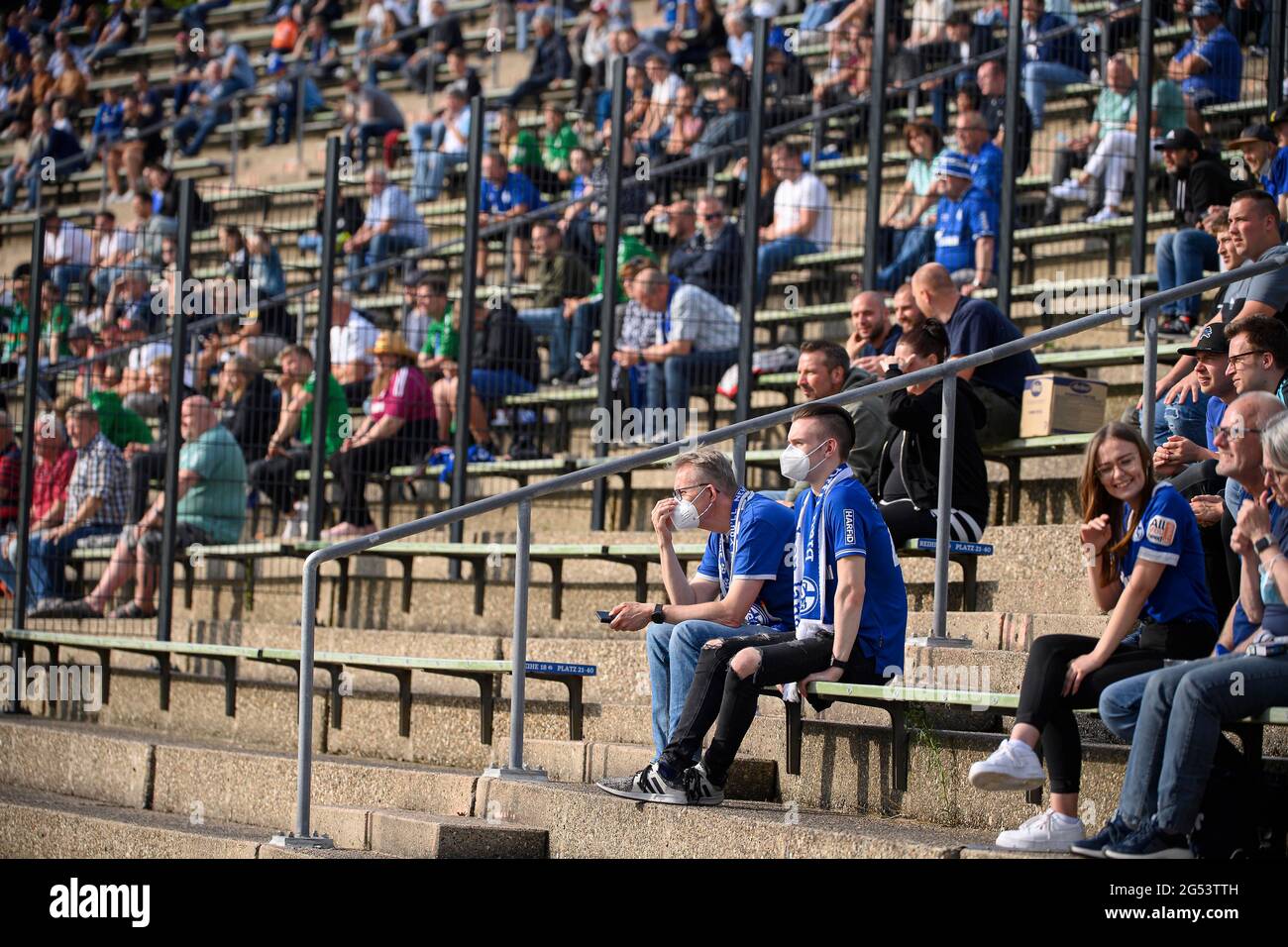 Feature, fans sit at a distance on the tribune in the Parkstadion Soccer test match, FC Schalke 04 (GE) - PSV Wesel-Lackhausen, 8: 0 on June 23, 2021 in Gelsenkirchen/Germany. Â Stock Photo