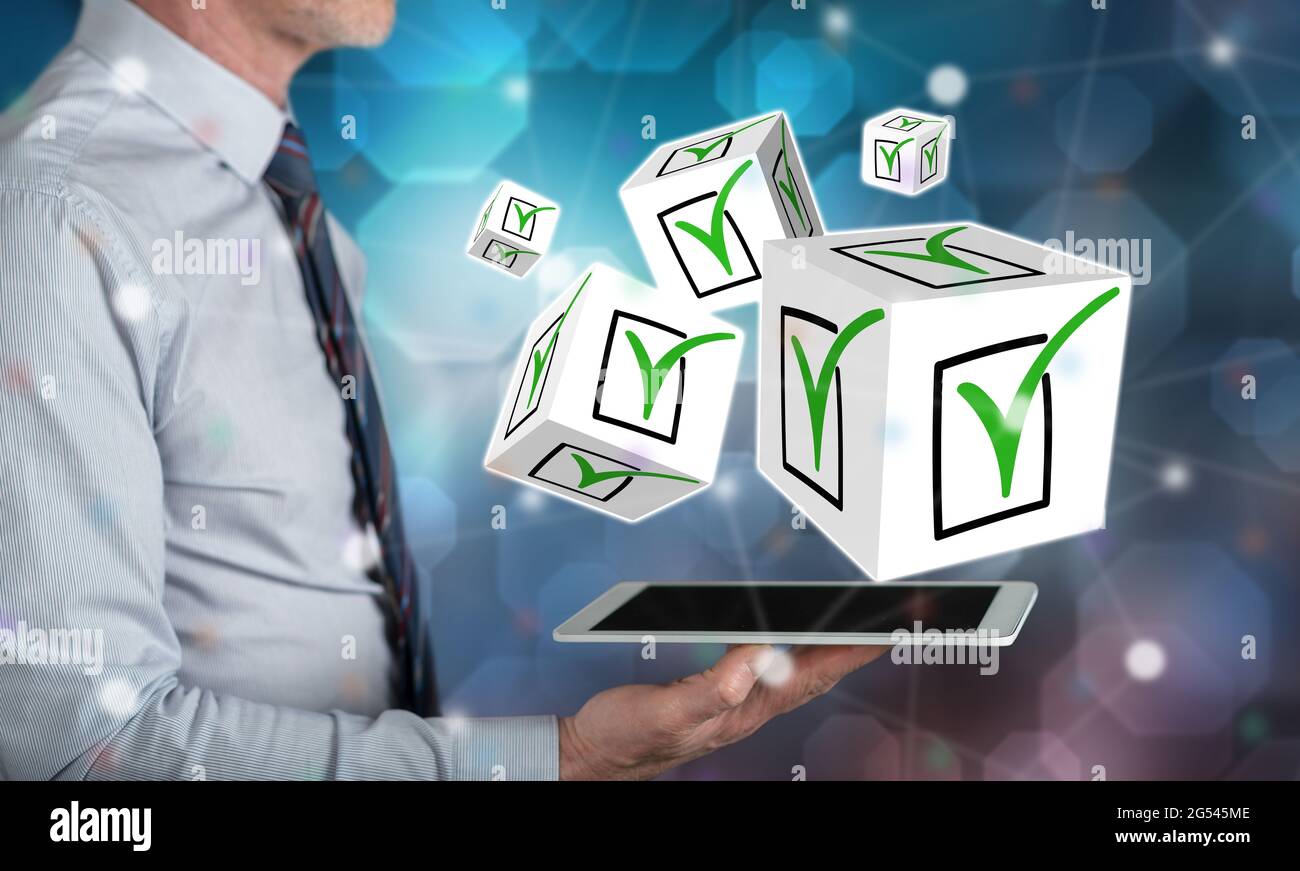 Validation concept above a tablet held by a man Stock Photo