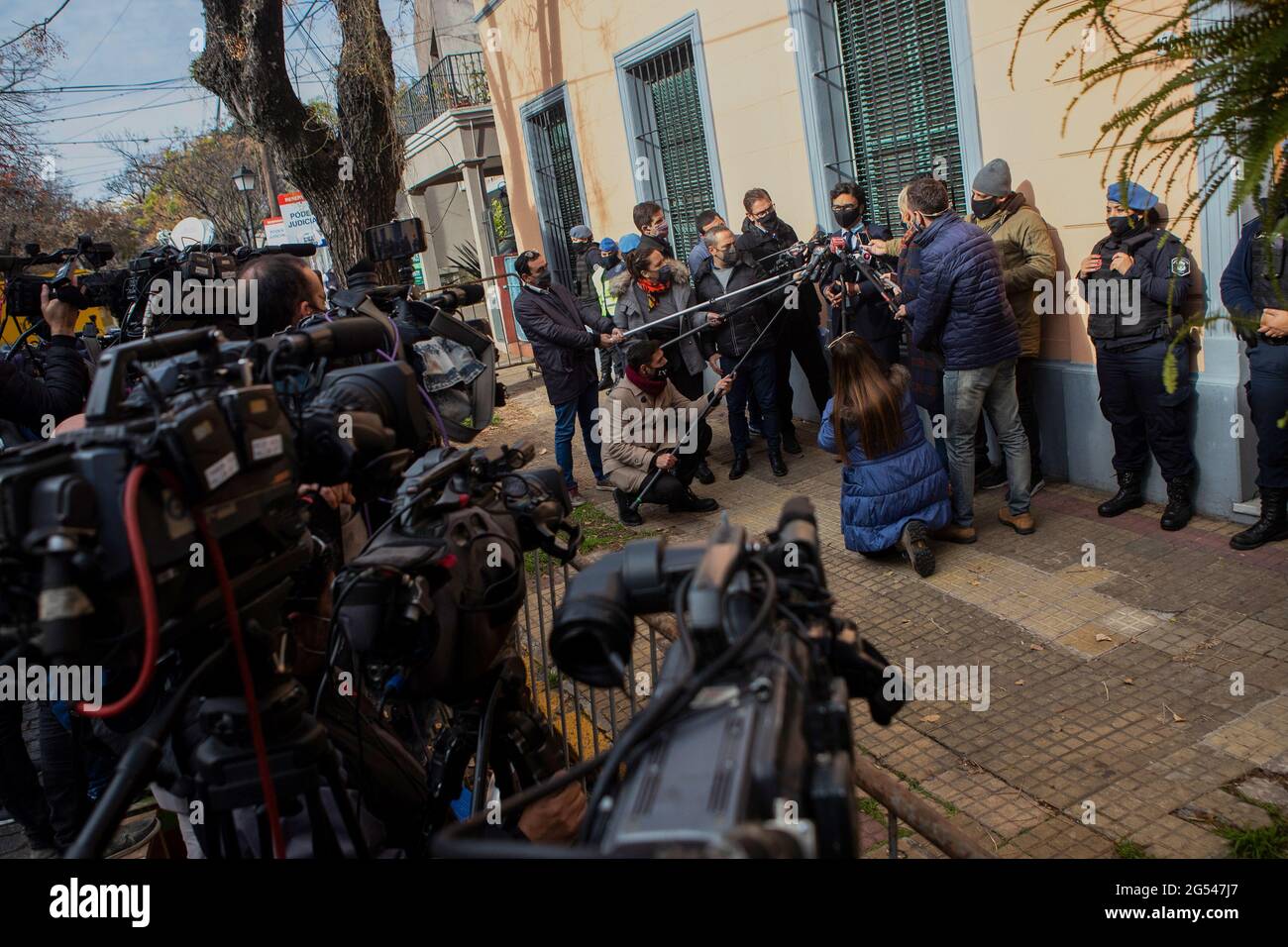 Buenos Aires, Argentina. 25th June, 2021. Vadim Mishanchuk (m., r), lawyer for the psychiatrist Cosakhov in the case on Maradona's death, speaks to journalists outside the prosecutor's office. Prosecutors in San Isidro, north of Buenos Aires, are questioning the Argentine soccer legend's doctors and nurses. Investigators are accusing Maradona's personal physician Luque, psychiatrist Cosachov and several caregivers of manslaughter. Credit: Matias Baglietto/dpa/Alamy Live News Stock Photo