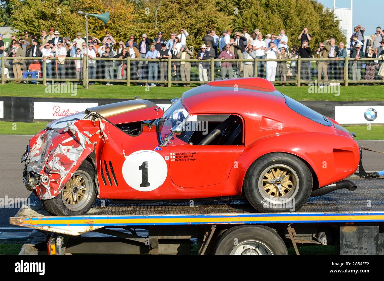 Shelby AC Cobra classic racing car being transported away following crashing during racing at the Goodwood Revival 2011, UK. Smashed front Stock Photo