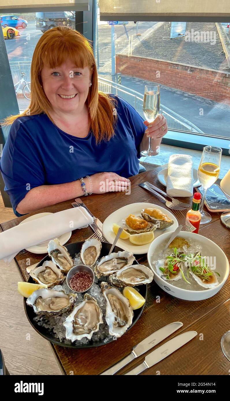 Shellfish ice meal champagne meals redhead female woman eating o hires