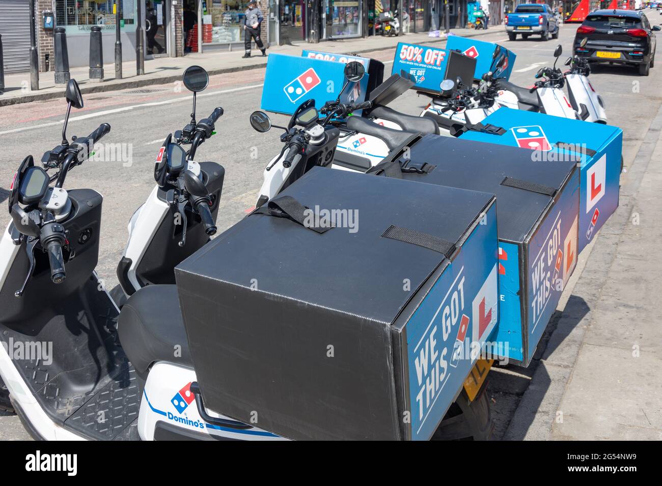 Domino's Pizza delivery scooters, Camden High Street, Camden Town, London Borough of Camden, Greater London, England, United Kingdom Stock Photo