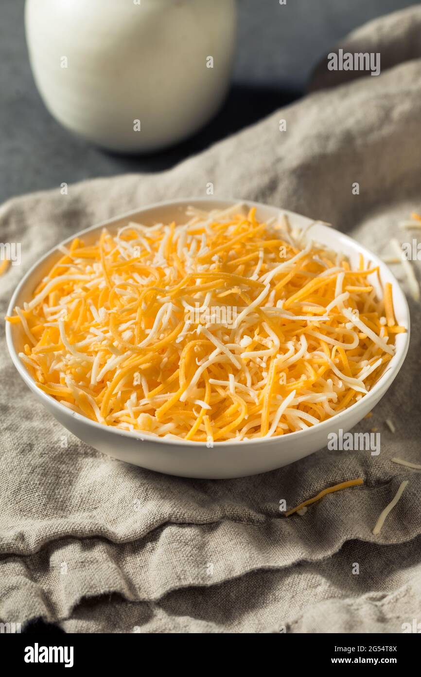 Organic Shredded Mexican Cheese Mix in a Bowl Stock Photo