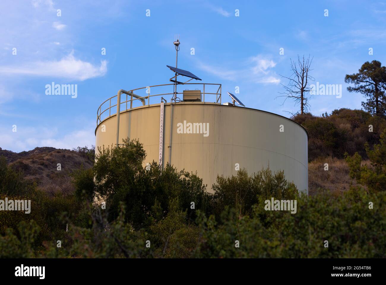 Large water tank at sunset Stock Photo