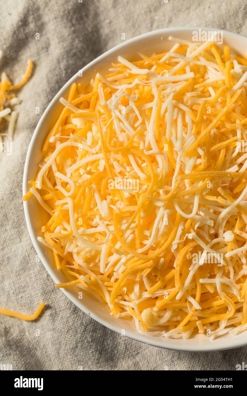 Organic Shredded Mexican Cheese Mix in a Bowl Stock Photo