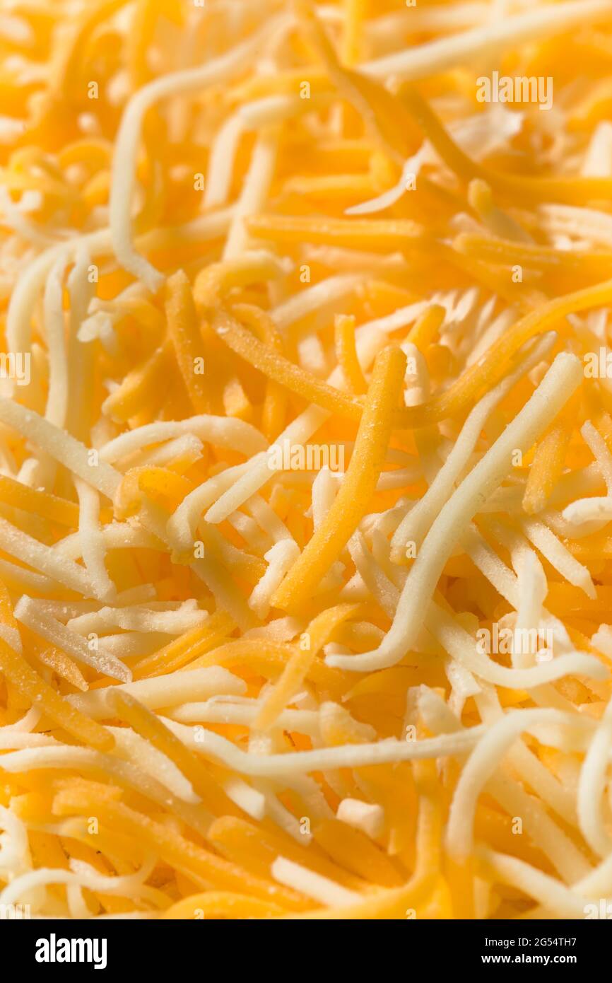 Organic Shredded Mexican Cheese Mix in a Bowl Stock Photo