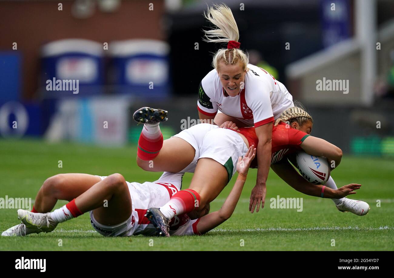 England's Caitlin Beevers (left) and Amy Hardcastle tackle Wales' Lowri Norkett during the women's international match at the Halliwell Jones Stadium, Warrington. Picture date: Friday June 25, 2021. Stock Photo
