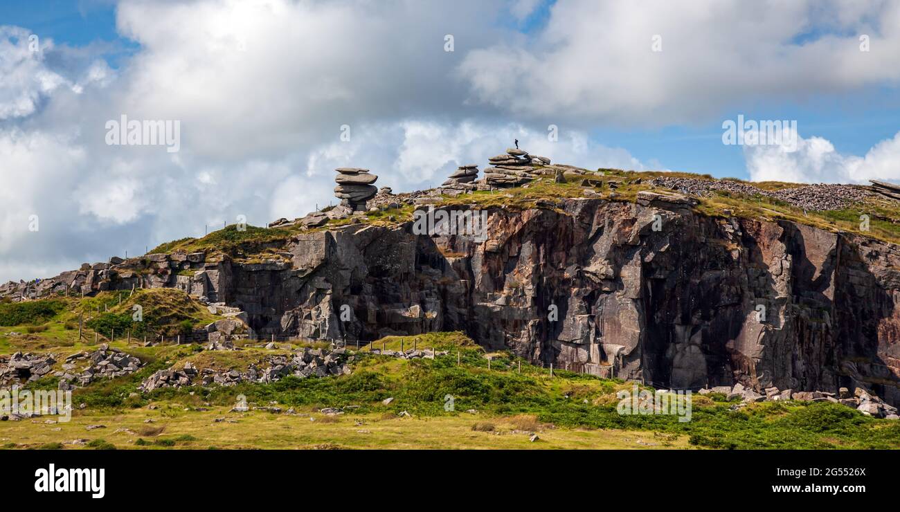 The Cheesewring natural rock formation seems to be balanced precariously over the disused Cheesewring Quarry at Stowe's Hill, Bodmin Moor in Cornwall. Stock Photo