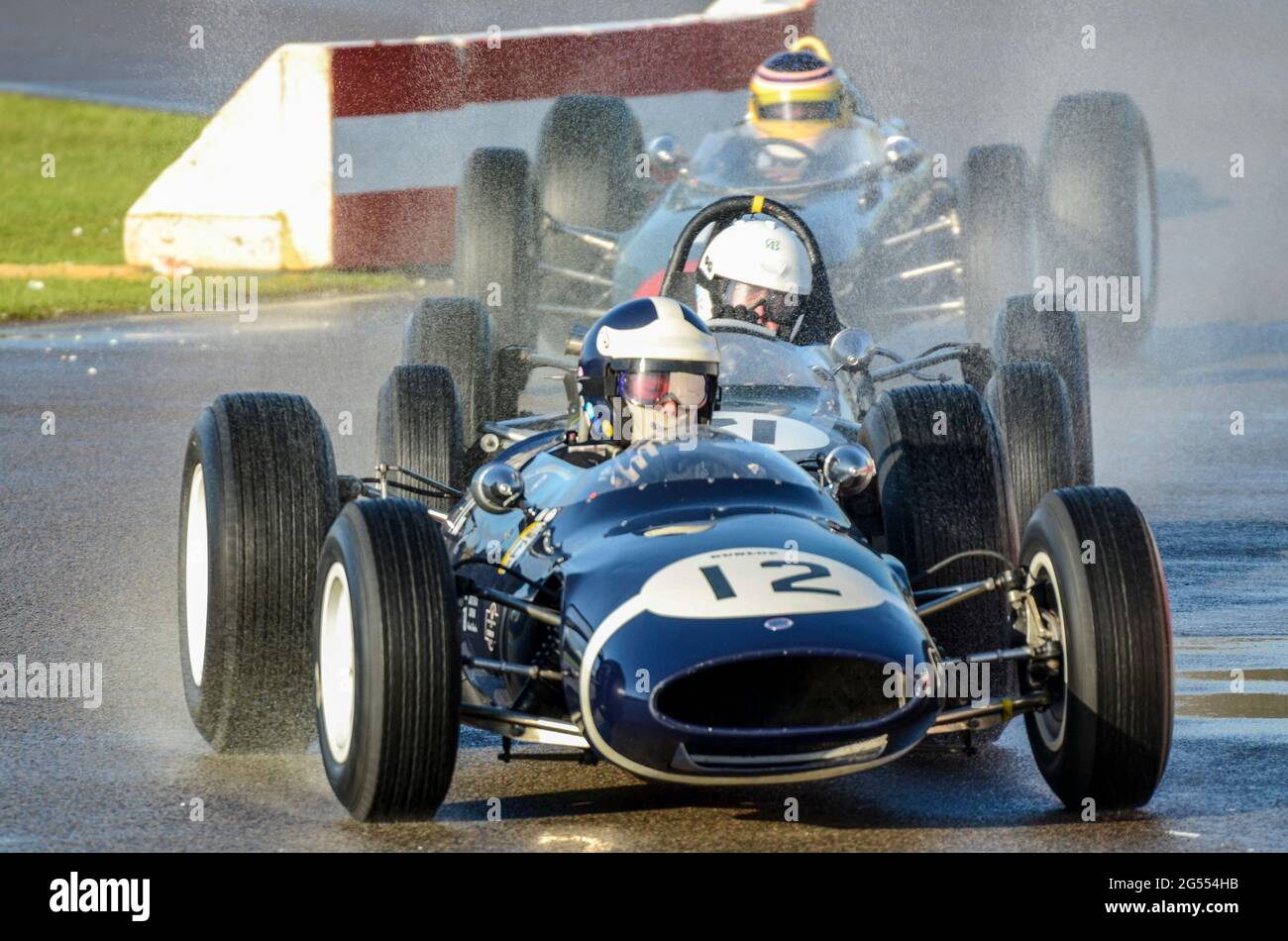 Cooper Climax T66 classic racing car racing in the Glover Trophy at the Goodwood Revival 2011, on a wet track after rain. Vintage Grand Prix car Stock Photo