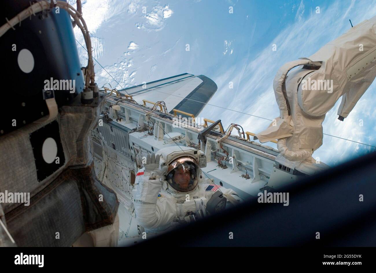 ONBOARD SPACE SHUTTLE DISCOVERY - 08 July 2006 - Astronaut Piers J Sellers, STS-121 mission specialist, waves to a crewmate inside the Space Shuttle D Stock Photo