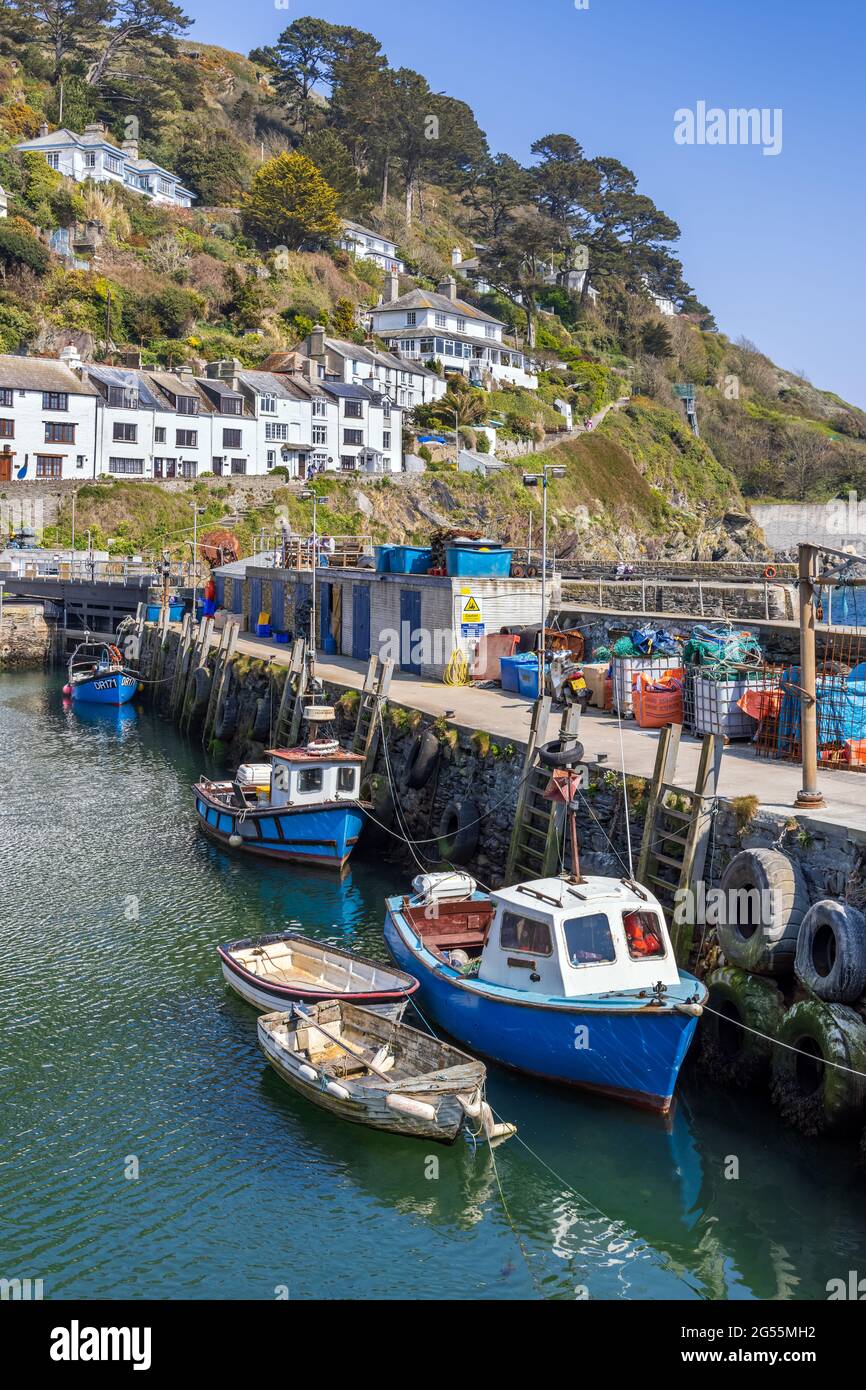Fishing boats moored by the harbour wall at Polperro, a charming and picturesque fishing village in south east Cornwall. Stock Photo