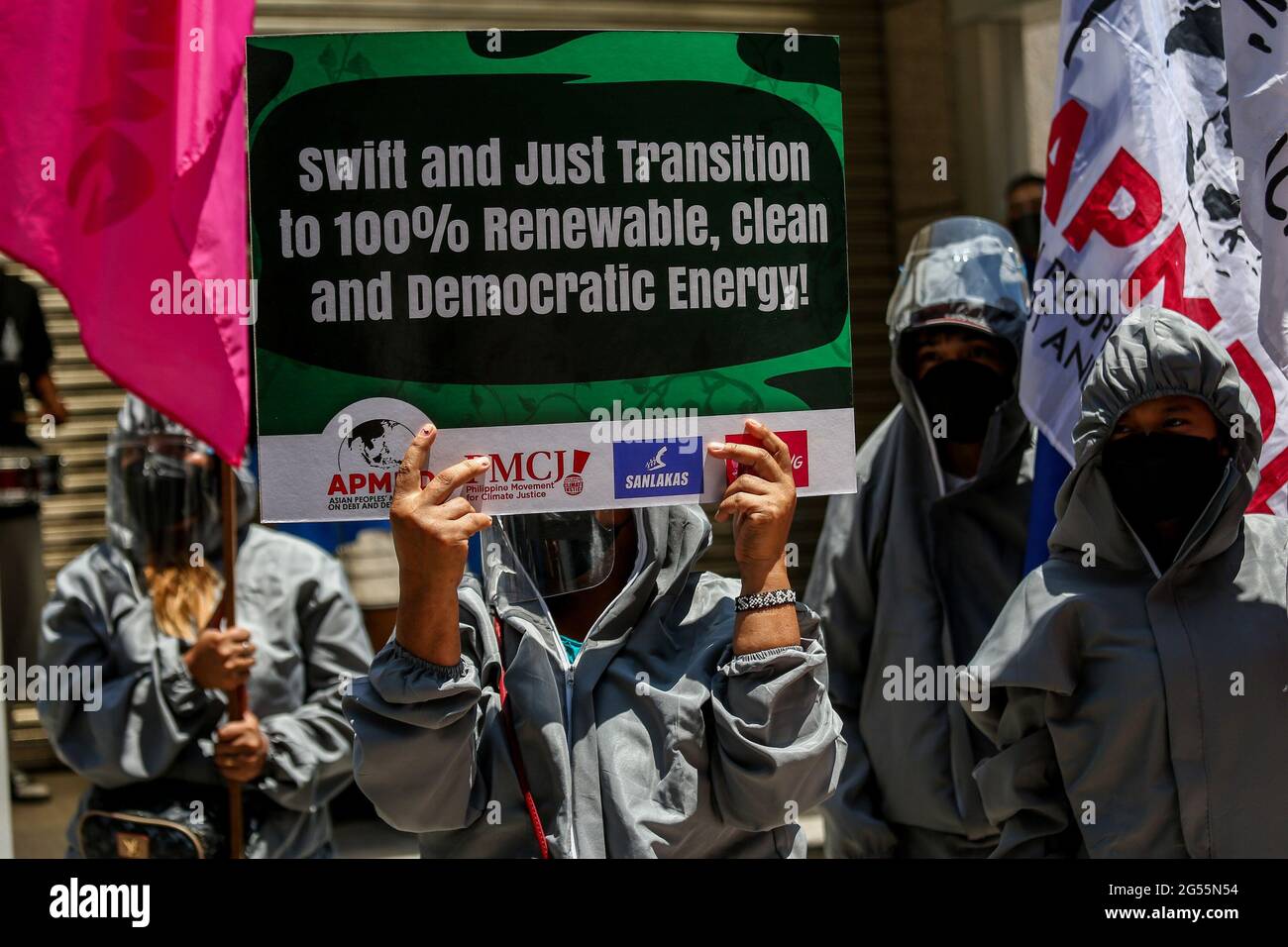 Climate activists dressed in PPE suits protest outside the Asian Development Bank (ADB) headquarters in Mandaluyong City. The group called on ADB—currently hosting the Asia Clean Energy Forum—and participating financial institutions to stop funding fossil fuel projects and make the shift to renewable energy. Metro Manila, Philippines. Stock Photo