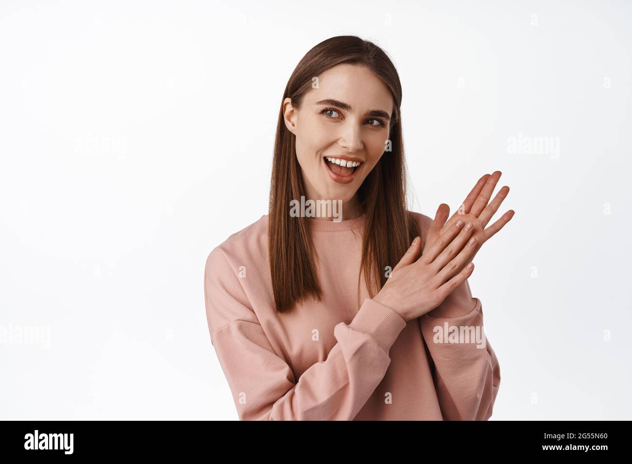 Image of satisfied girl rubbing hands and smiling, looking aside  thoughtful, has interesting idea with good money relish, standing against  white Stock Photo - Alamy
