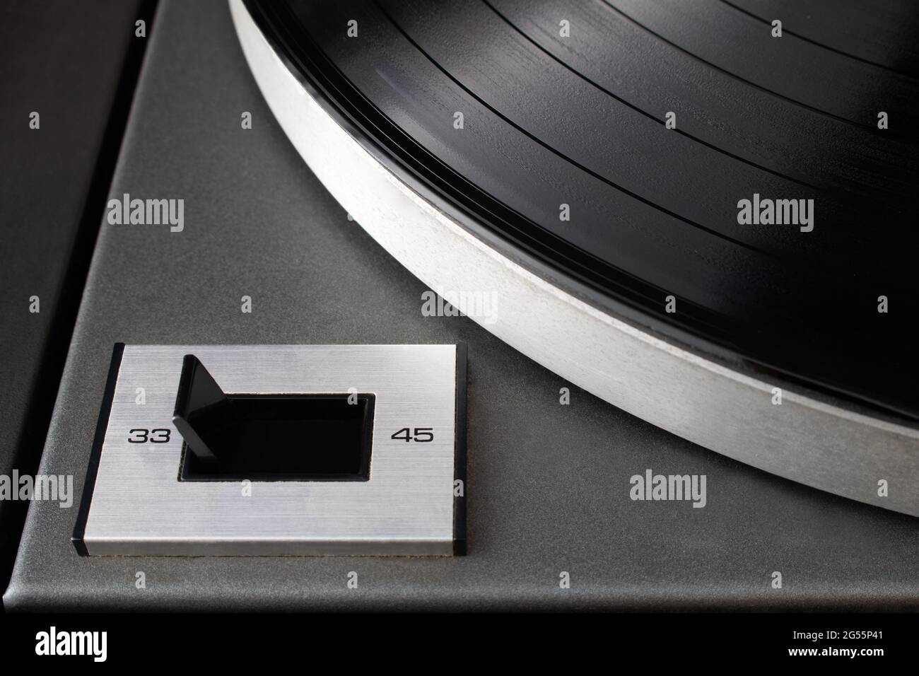 Close-up of speed rotation switch set to 33 RPM on vintage turntable vinyl record player Stock Photo