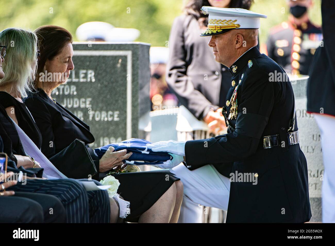 U.S. Marine Corps Commandant Gen. David Berger presents the flag to Jeanne Warner, wife of former U.S. Senator and Marine Corps 1st Lt. John Warner during his funeral in Arlington National Cemetery June 23, 2021 in Arlington, Virginia. Warner, a Senator for Virginia for 30-years and Secretary of the Navy died May 25th. Stock Photo