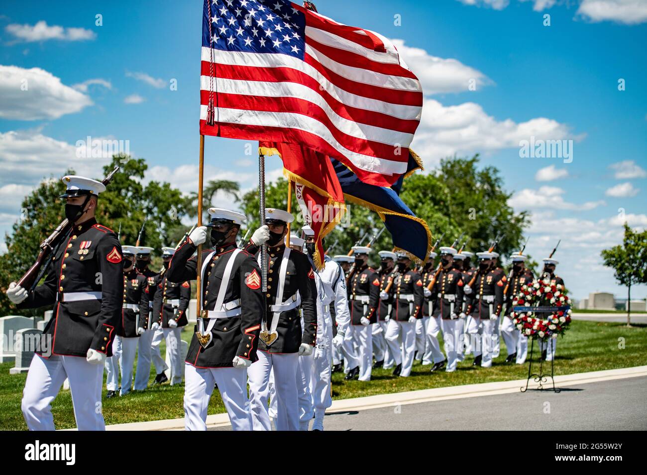 A U.S. Marine Corps color guard team troop the colors during a military funeral to honor former U.S. Senator and Marine Corps 1st Lt. John Warner in Section 4 of Arlington National Cemetery June 23, 2021 in Arlington, Virginia. Warner, a Senator for Virginia for 30-years and Secretary of the Navy died May 25th. Stock Photo