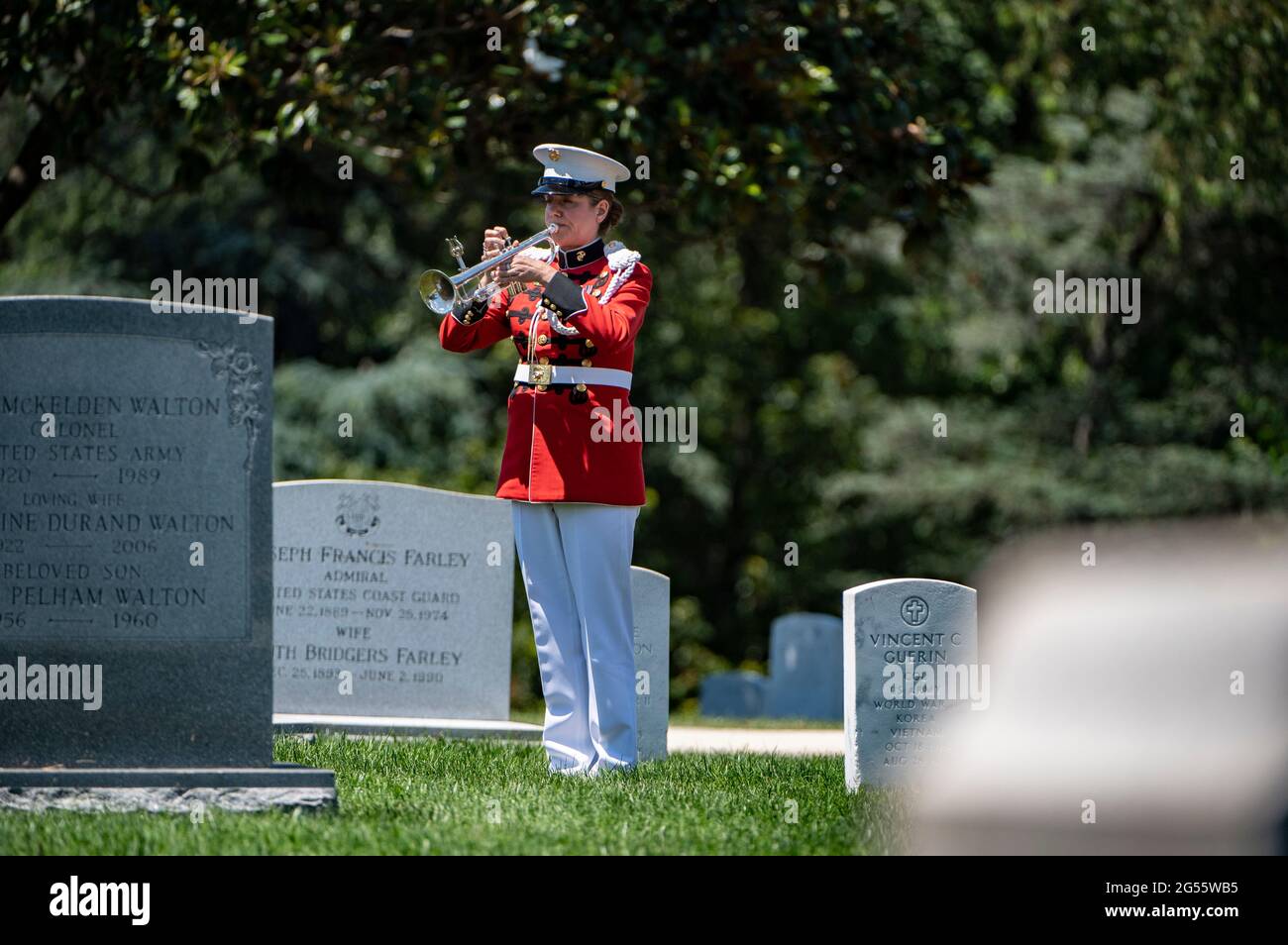 A trumpeter from the The President’s Own Marine Band plays Taps during a full honors ceremony for former U.S. Senator and Marine Corps 1st Lt. John Warner during his funeral in Arlington National Cemetery June 23, 2021 in Arlington, Virginia. Warner, a Senator for Virginia for 30-years and Secretary of the Navy died May 25th. Stock Photo