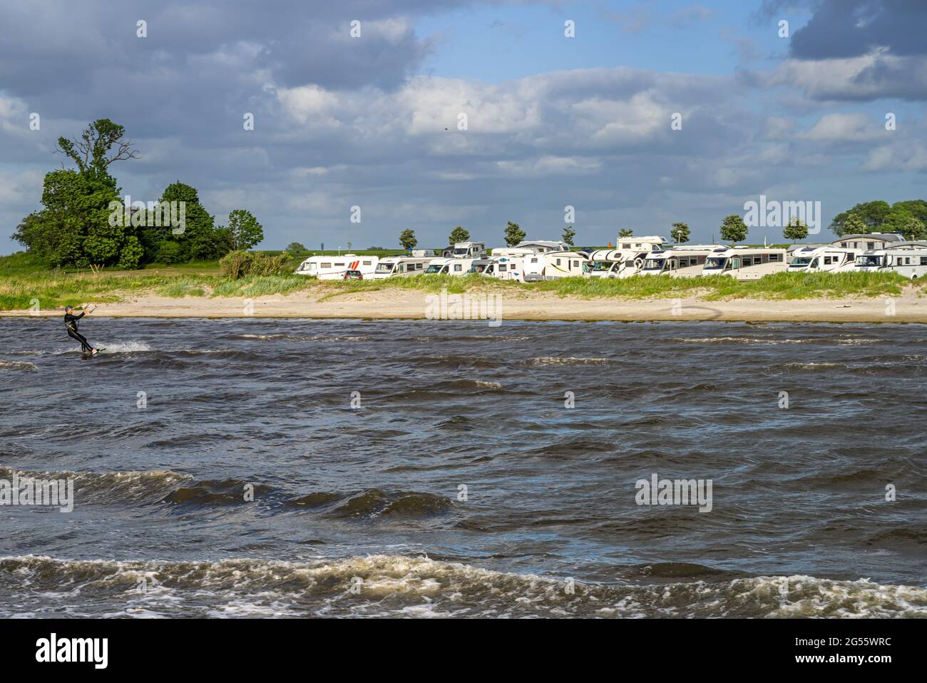 June 13, 2021 - Malmo, Sweden: RVs parked by a beach a windy summer day. The sales of RVs have increased since the pandemic has made international travel more difficult Stock Photo