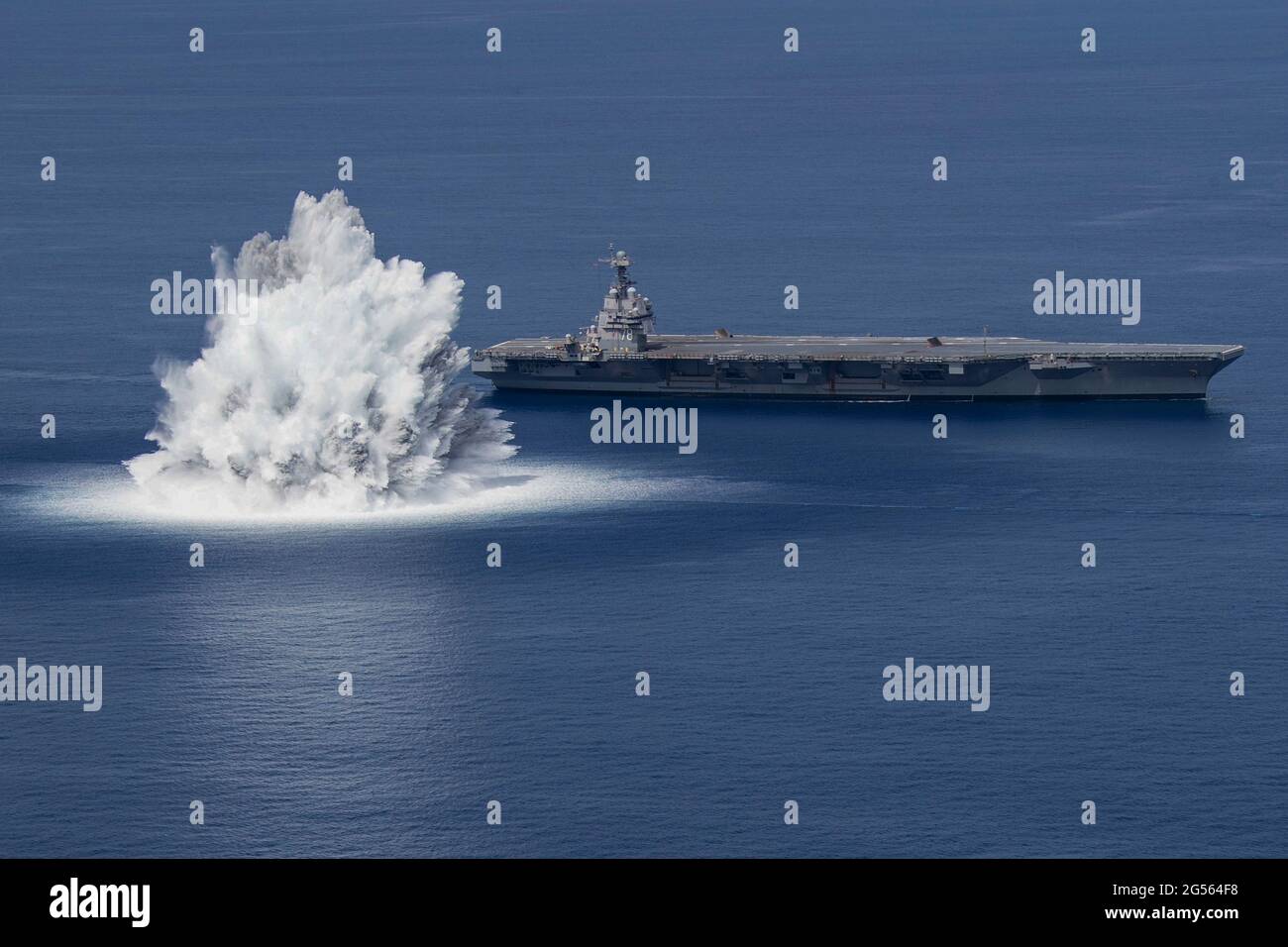 The U.S. Navy USS Gerald R. Ford, lead ship in the Ford Class Aircraft Carriers, completes the first scheduled explosive event of Full Ship Shock Trials while underway June 18, 2021 in the Atlantic Ocean. The U.S. Navy conducts shock trials of new ship designs using live explosives to confirm performance in battle conditions. Stock Photo