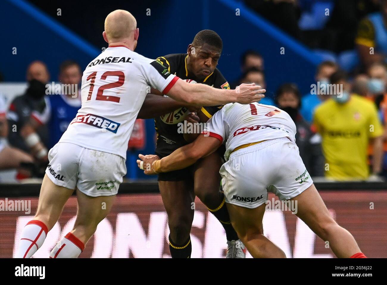 Warrington, UK. 25th June, 2021. Jermaine McGillvary (5) of the Combined Nations All Stars is tackled by Joe Philbin (17) and Liam Farrell (12) of England in, on 6/25/2021. (Photo by Craig Thomas/News Images/Sipa USA) Credit: Sipa USA/Alamy Live News Credit: Sipa USA/Alamy Live News Stock Photo