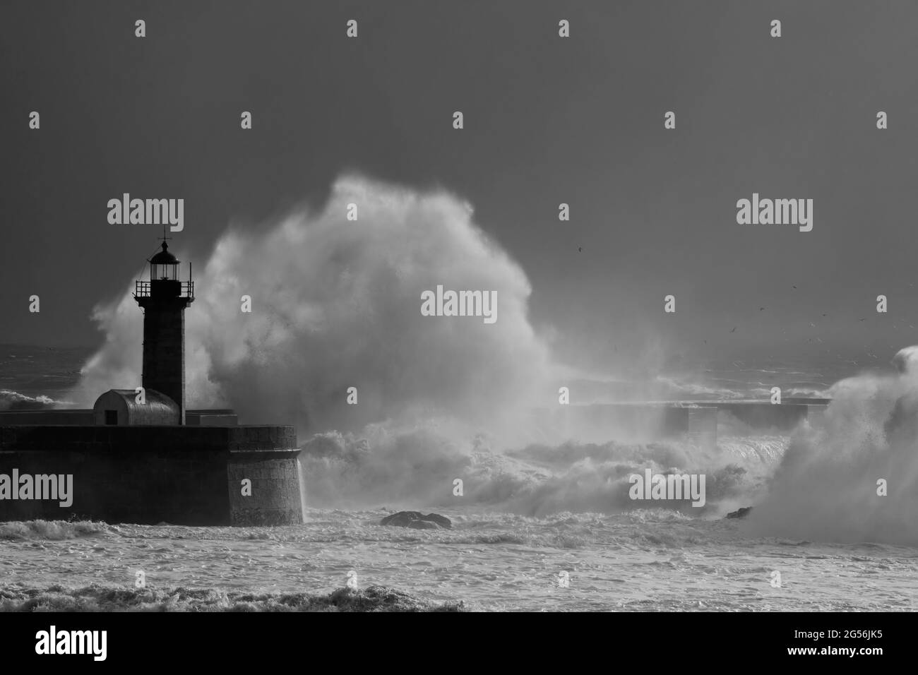 Big sea wave splash with beautiful stormy light. Douro river mouth, Porto, Portugal. Stock Photo