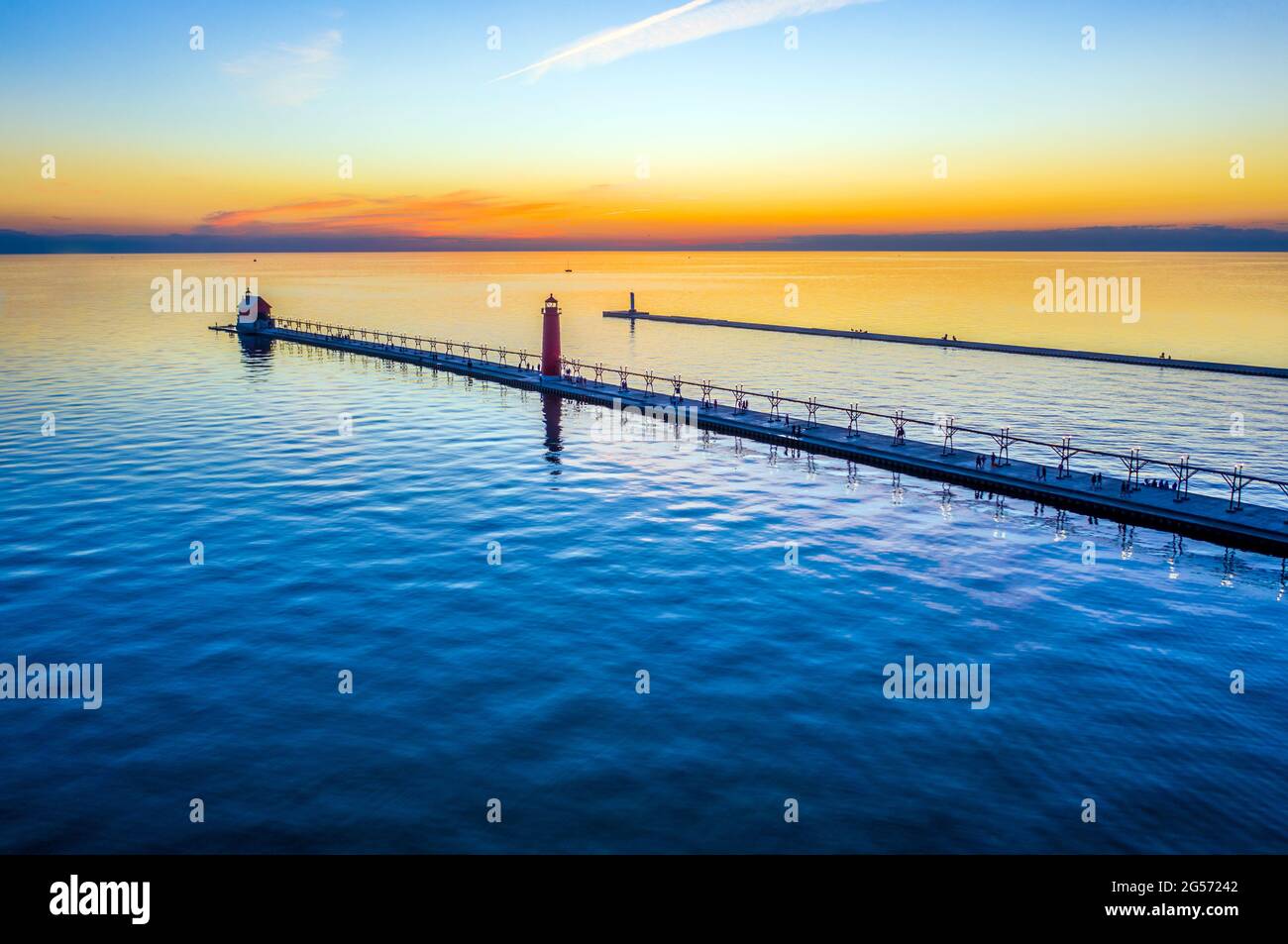 Aerial sunset view of the Grand Haven South Pier Lighthouses, located where the Grand River meets Lake Michigan at Grand Haven State Park Stock Photo