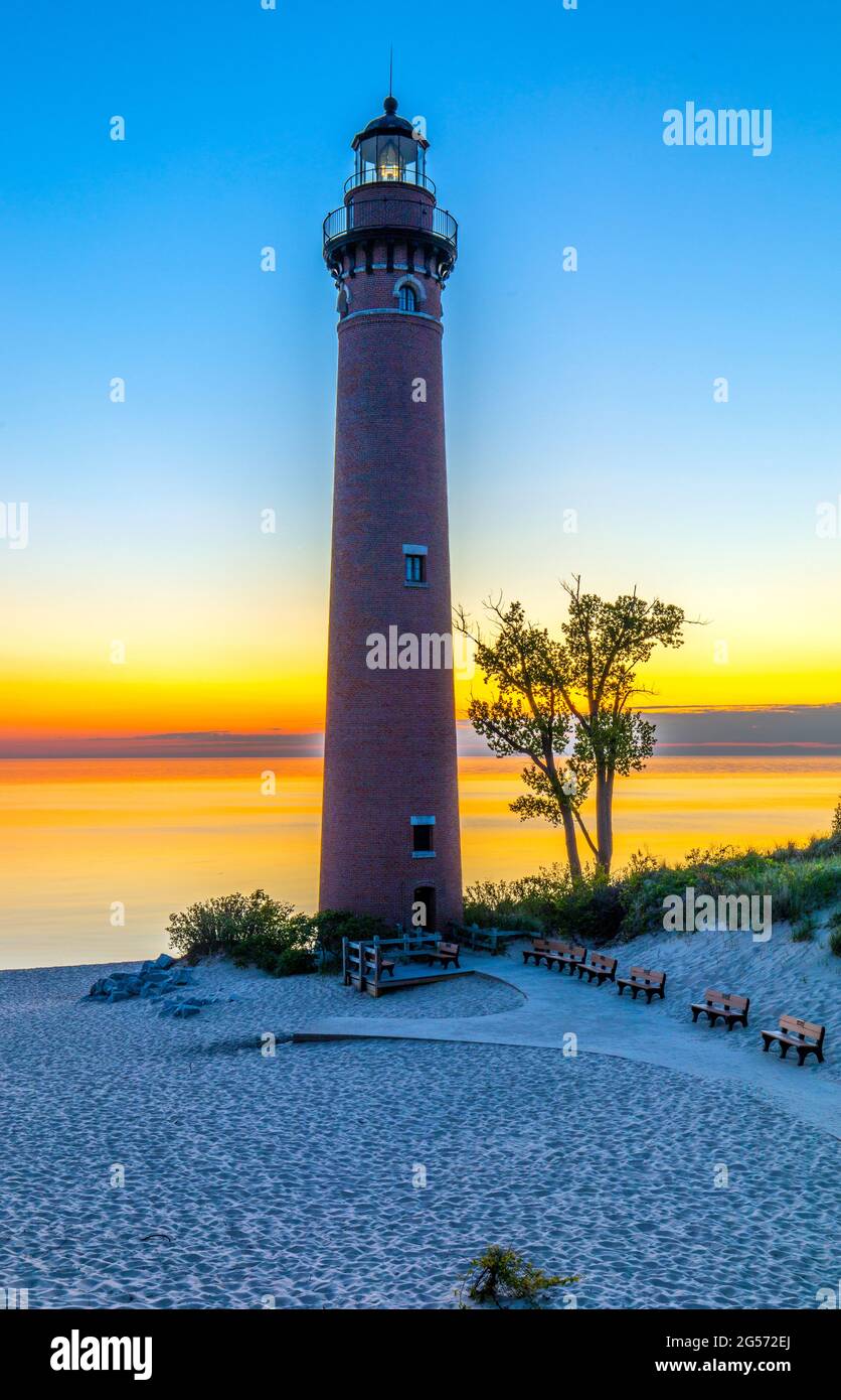 Little Sable Point Lighthouse with the sun setting over Lake Michigan, near Silver Lake State Park and Mears, just south of Ludington, Michigan Stock Photo