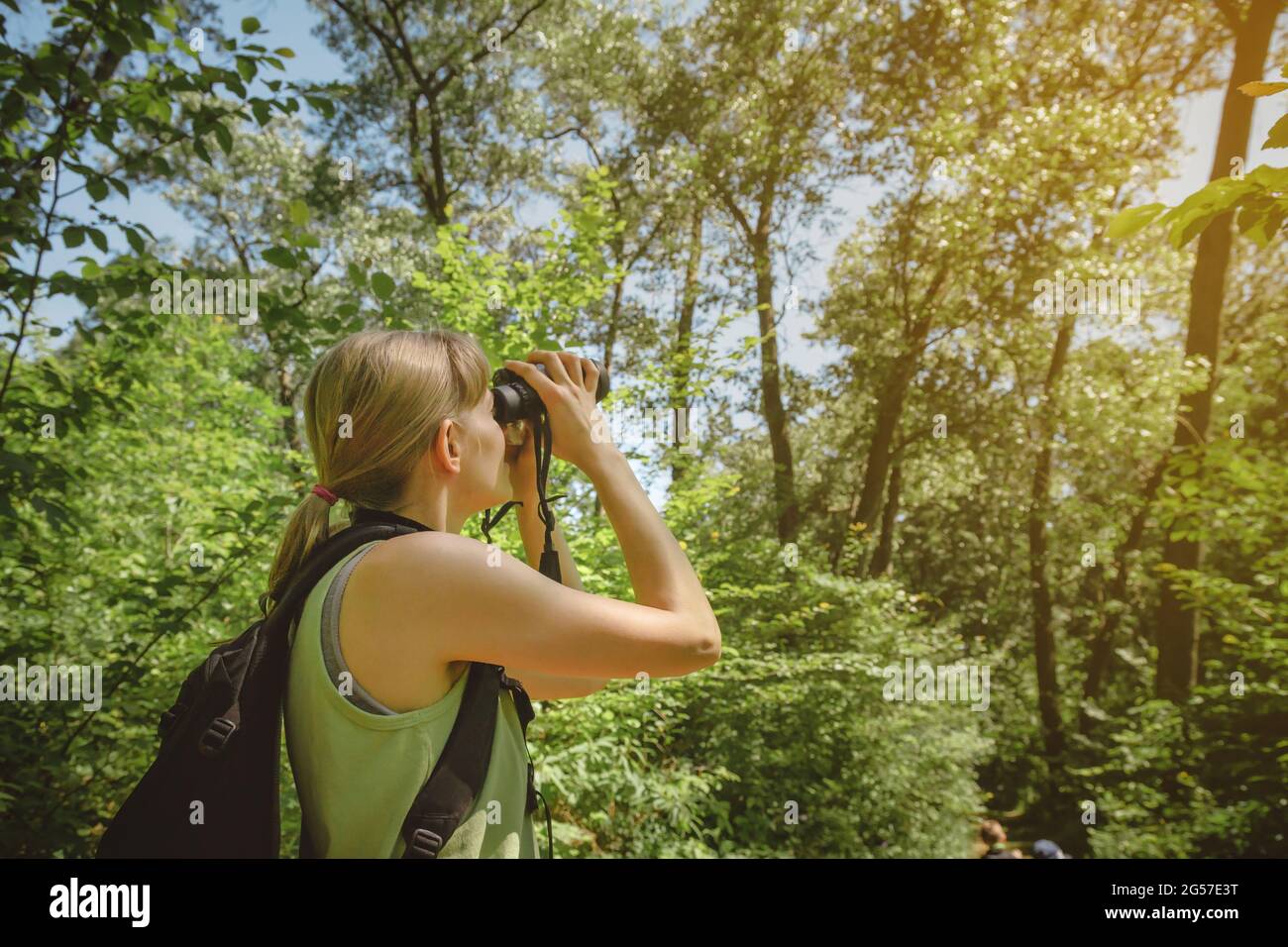 Young woman bird watching with binoculars at Indiana Dunes State Park. Stock Photo