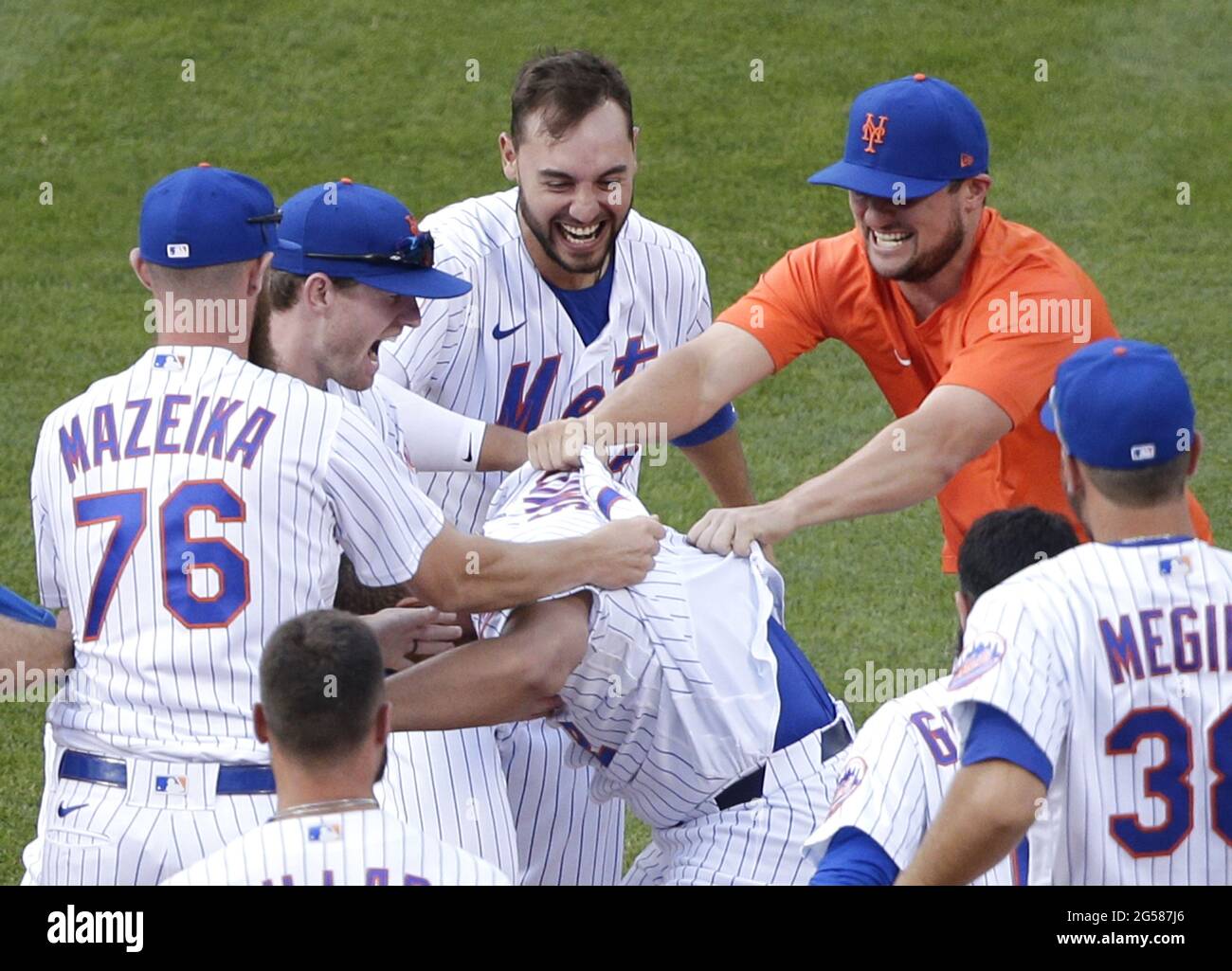 Queens, USA. 25th June, 2021. New York Mets players celebrate with Dominic Smith who hits a walk off game winning RBI single in the bottom of the 8th inning in game one of a double header against the Philadelphia Phillies at Citi Field on Friday, June 25, 2021 in New York City. The Mets defeated the Phillies 2-1 in extra innings. Photo by John Angelillo/UPI Credit: UPI/Alamy Live News Stock Photo