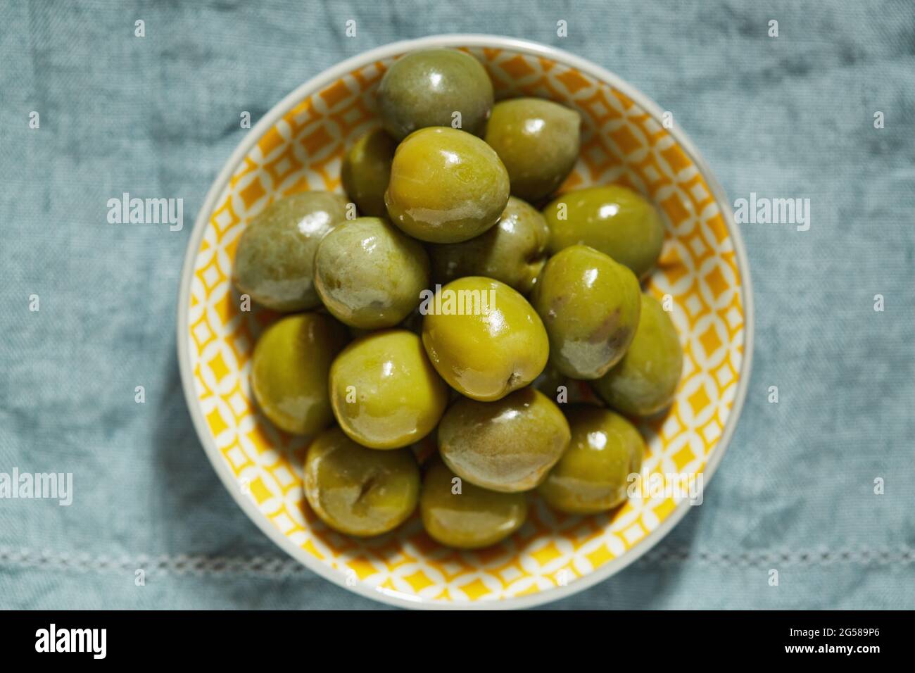 Overhead view of green olives in bowl Stock Photo Alamy