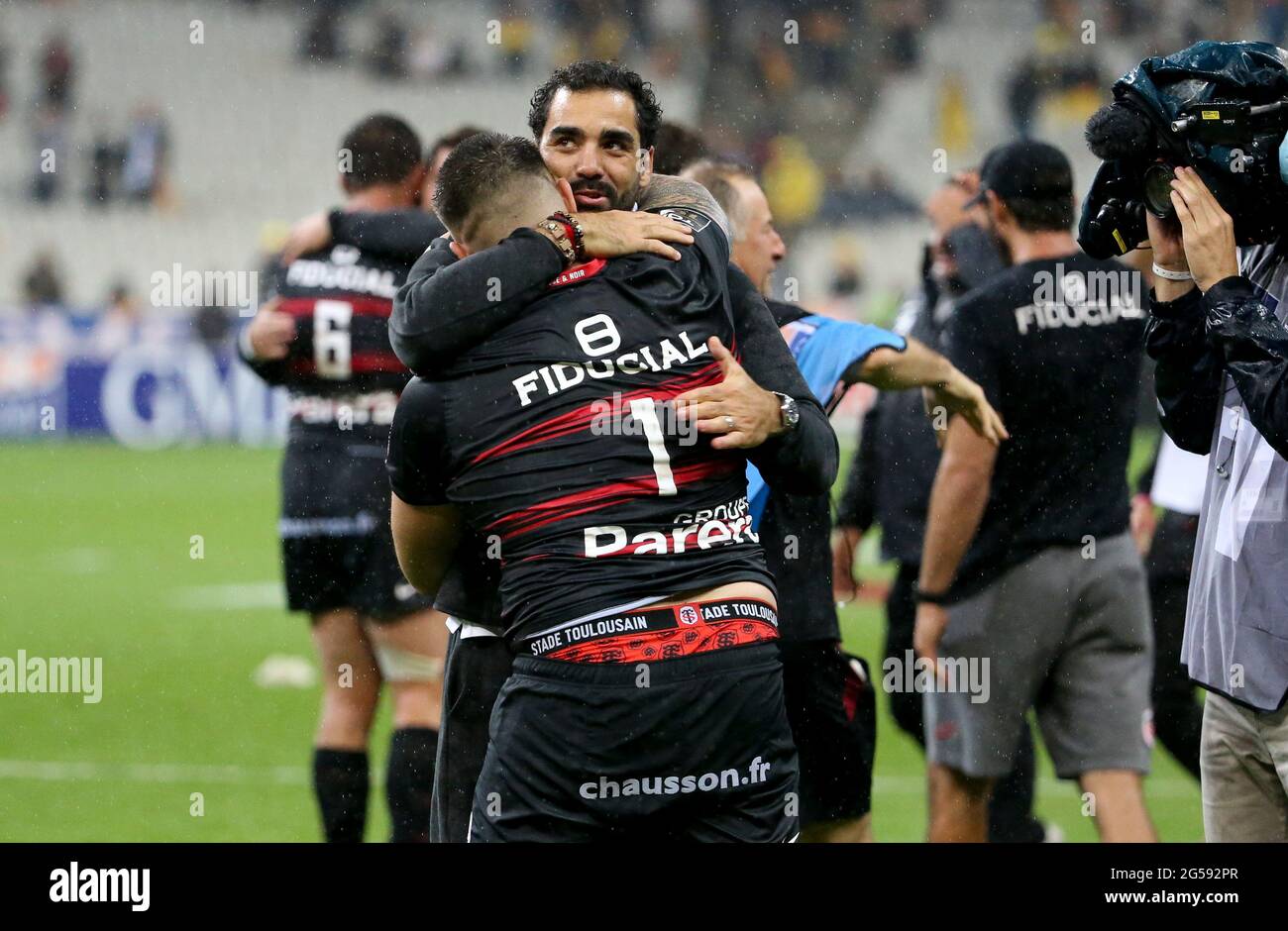 Paris, France. 25th June, 2021. Yoann Huget of Stade Toulousain hugs  teammate Cyril Baille to celebrate the victory following the French rugby  championship Top 14 Final between Stade Toulousain (Toulouse) and Stade
