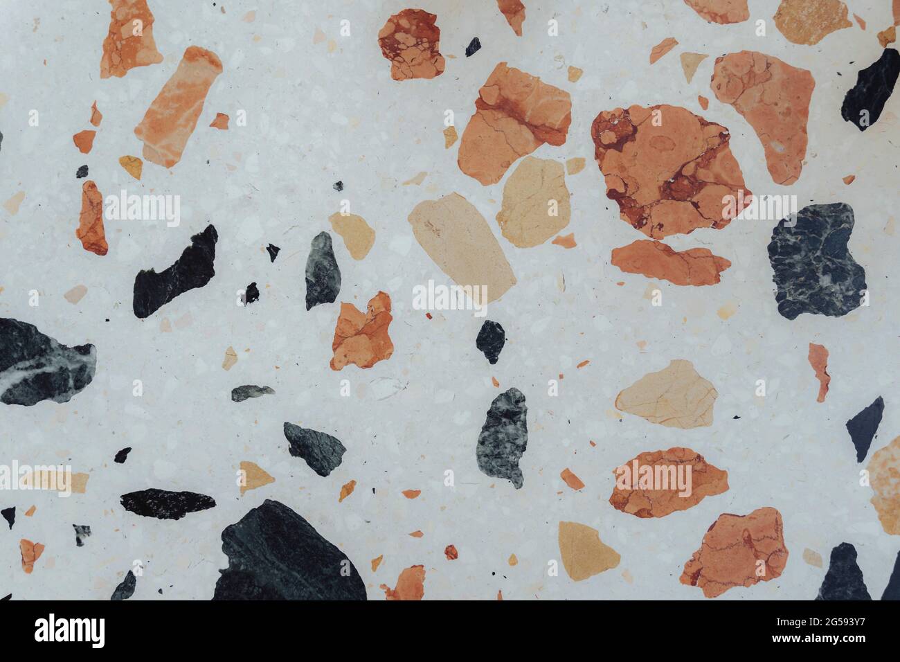 White marble bench texture with pastel blue and orange speckled pattern. Stock Photo