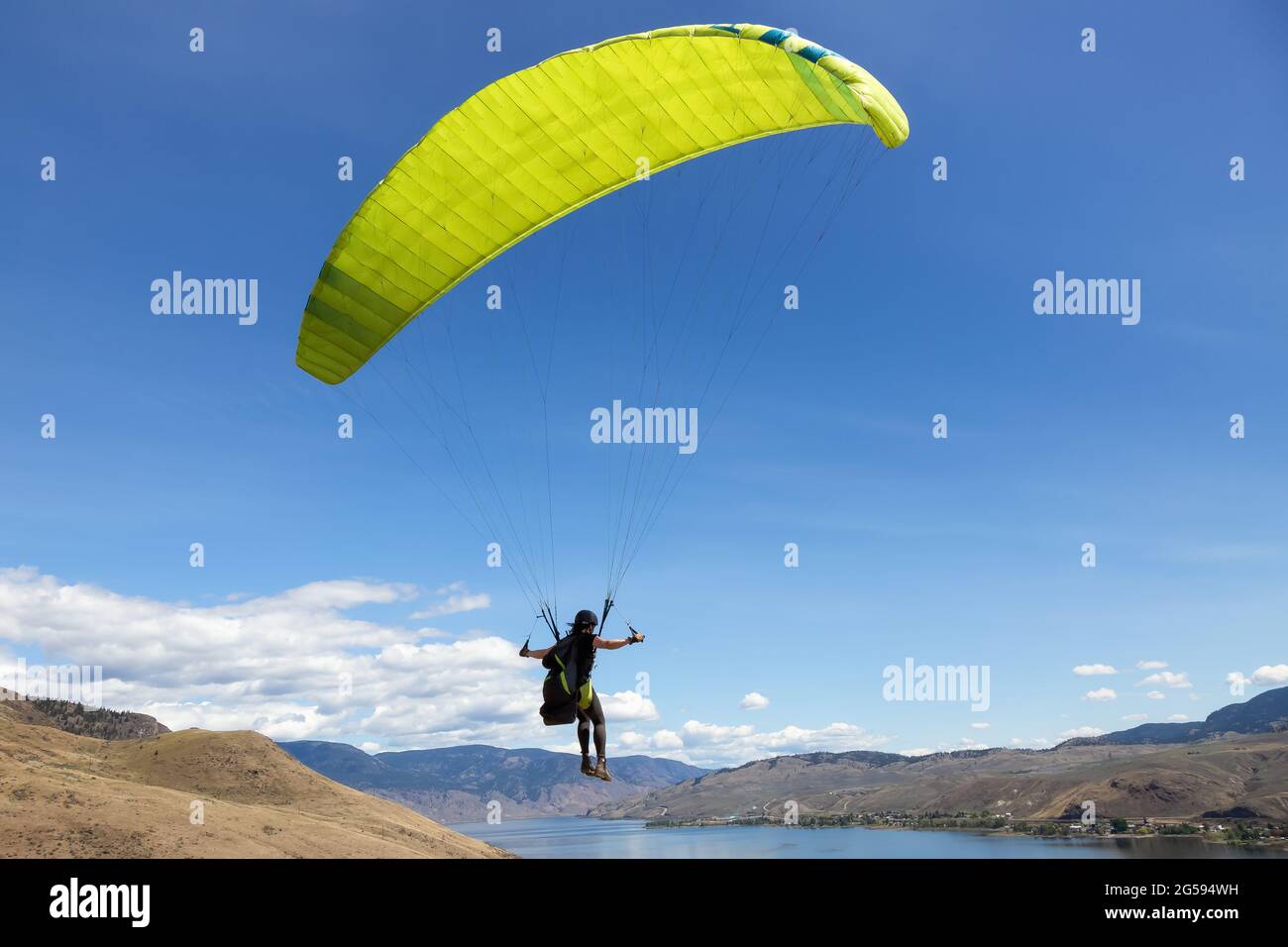 Adventurous Woman Learning to fly a Paraglider around the mountains Stock Photo Alamy