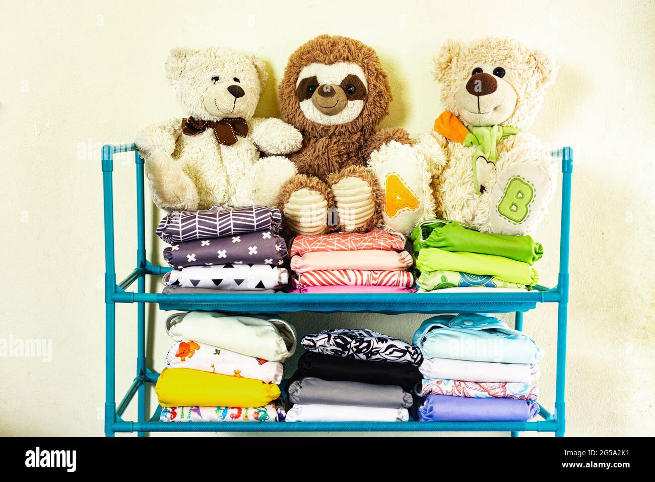 Stacked reusable diapers with stuffed animals on top Stock Photo - Alamy