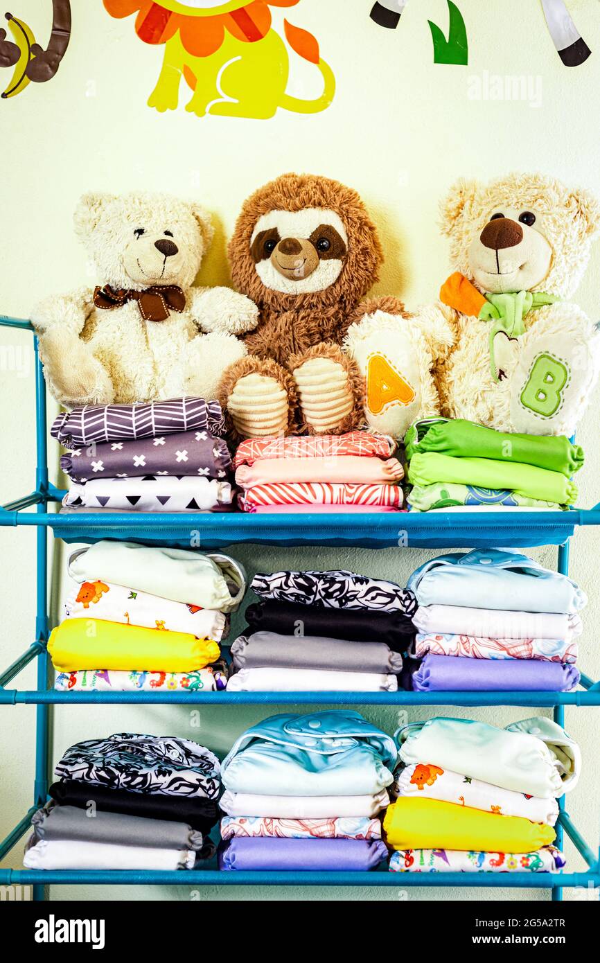 Stacked reusable diapers with stuffed animals on top Stock Photo - Alamy