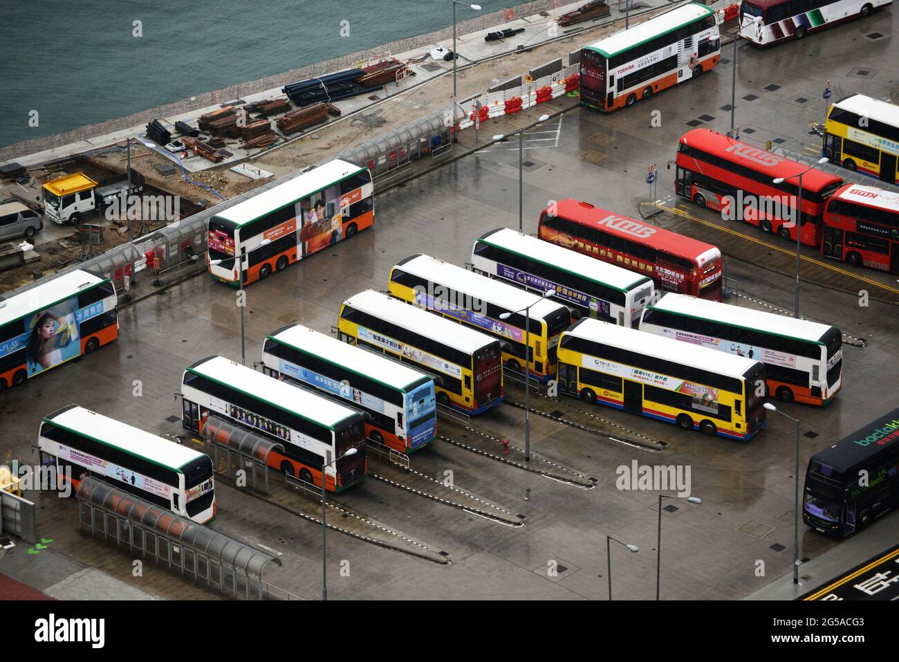 Aerial view of HK Double Decker busses in a parking lot in Wan Chai, Hong Kong. Stock Photo