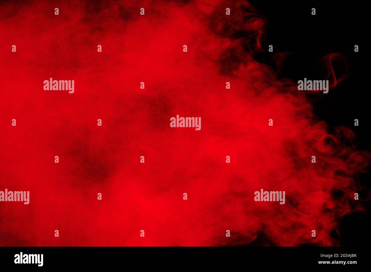 Red particles explosion on black background.Freeze motion of red dust splash. Stock Photo