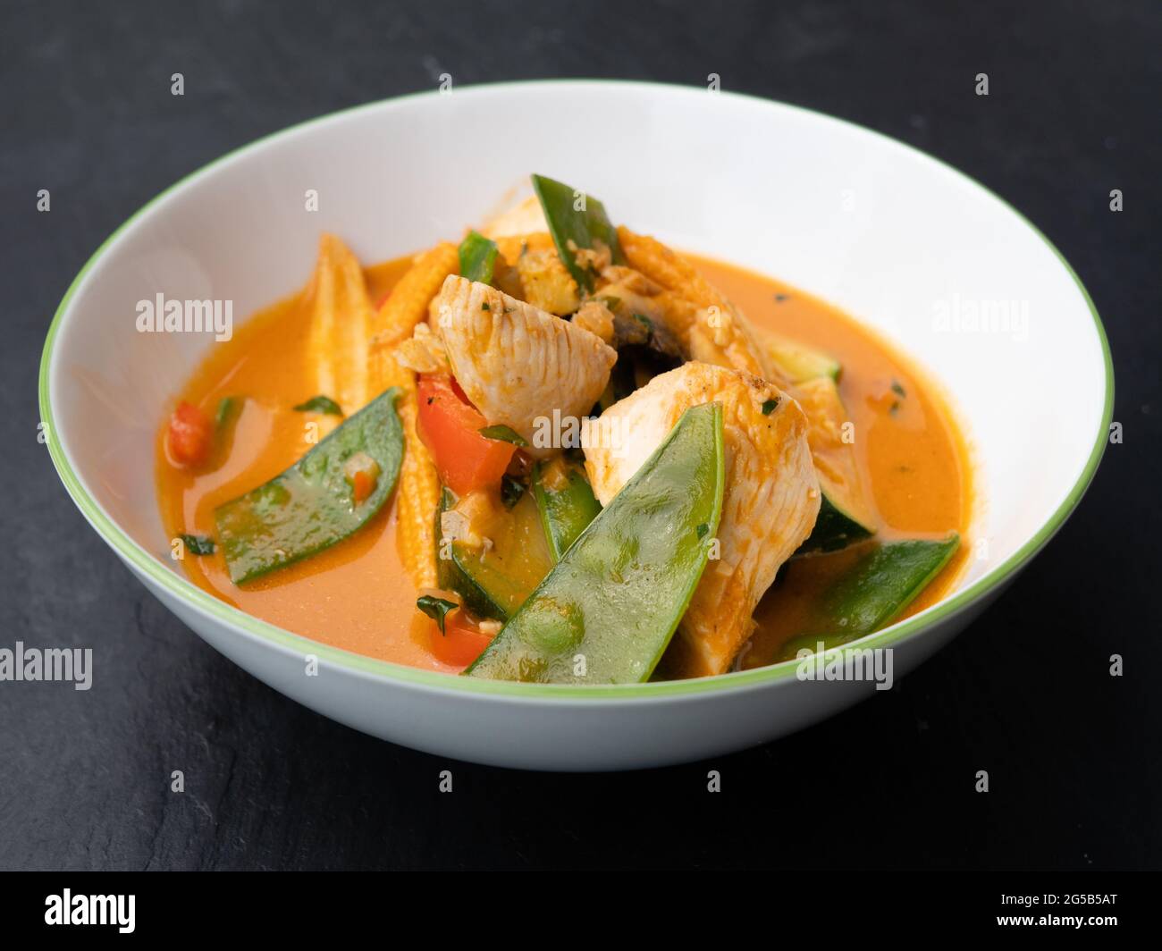 Spicy Red Thai Curry with Chicken and Vegetables in a Bowl Stock Photo